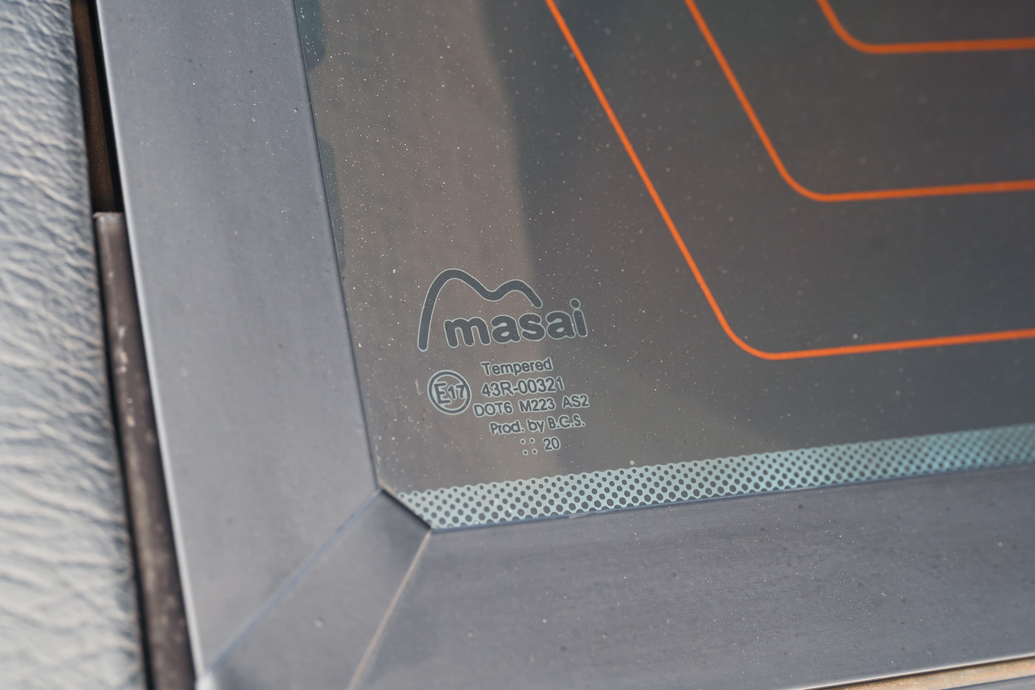Close up of the Masai branded, tempered rear window of a white 1995 Land Rover Range Rover County.
