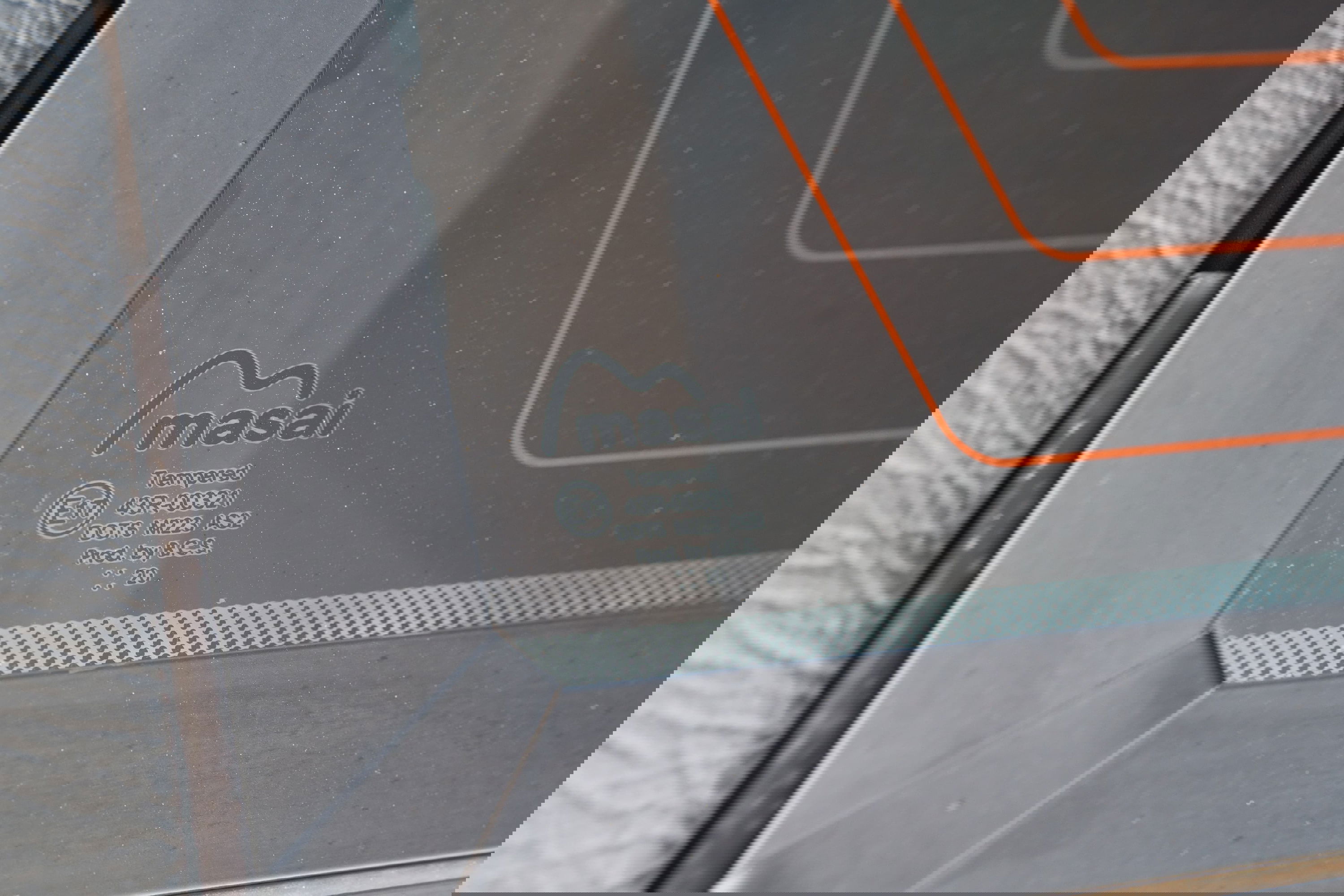 Close up of the Masai branded, tempered rear window of a white 1995 Land Rover Range Rover County.