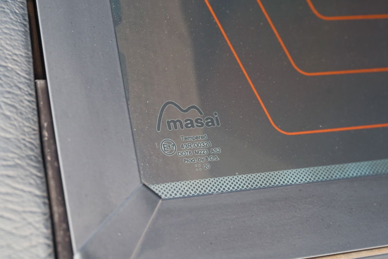 Close up of the Masai branded, tempered rear window of a white 1995 Land Rover Range Rover County.