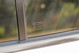 Close-up of a white 1995 Land Rover Range Rover County side window with Triplex toughened glass marking.