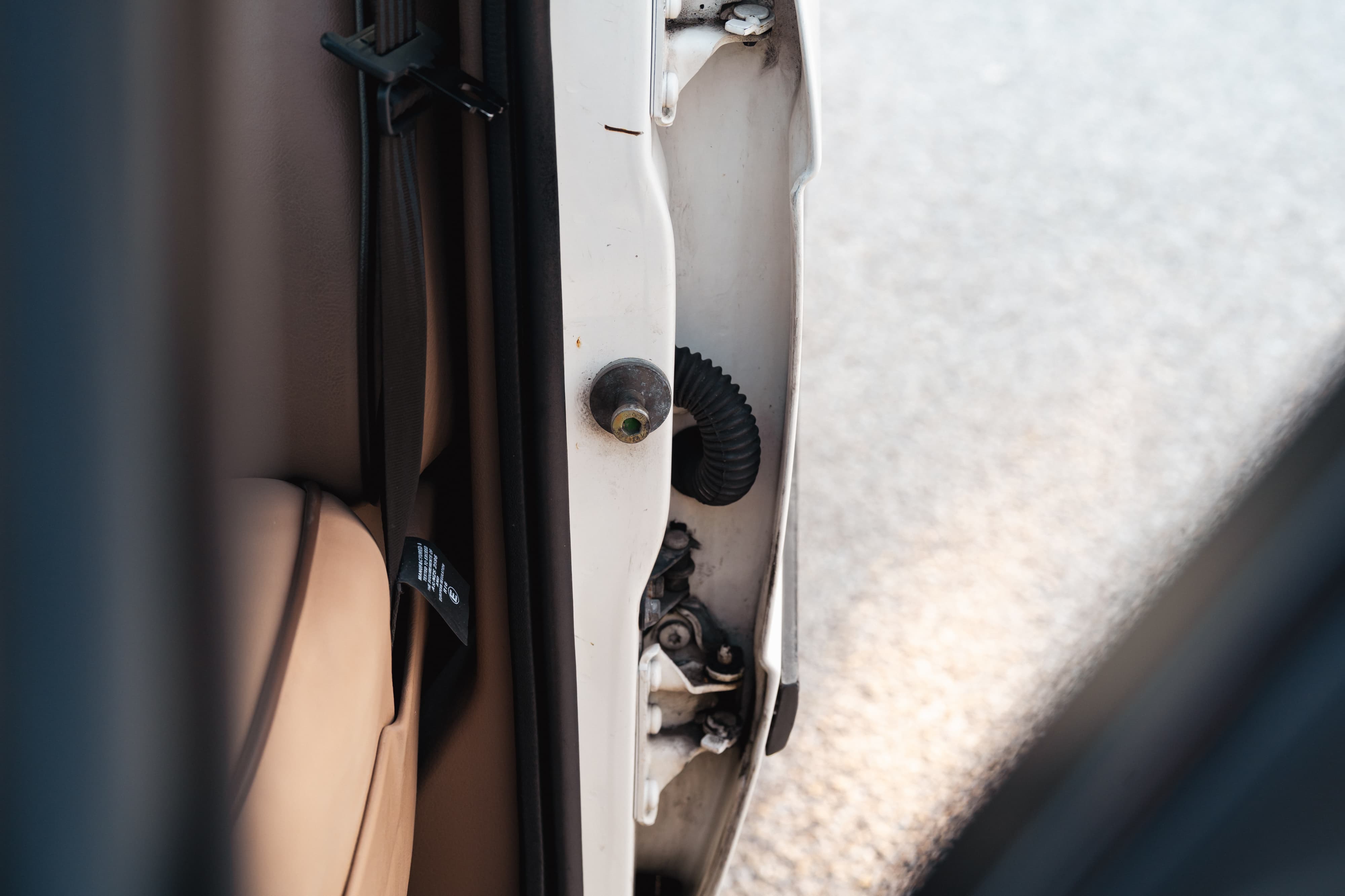 White 1995 Land Rover Range Rover County door latch mechanism and interior trim.