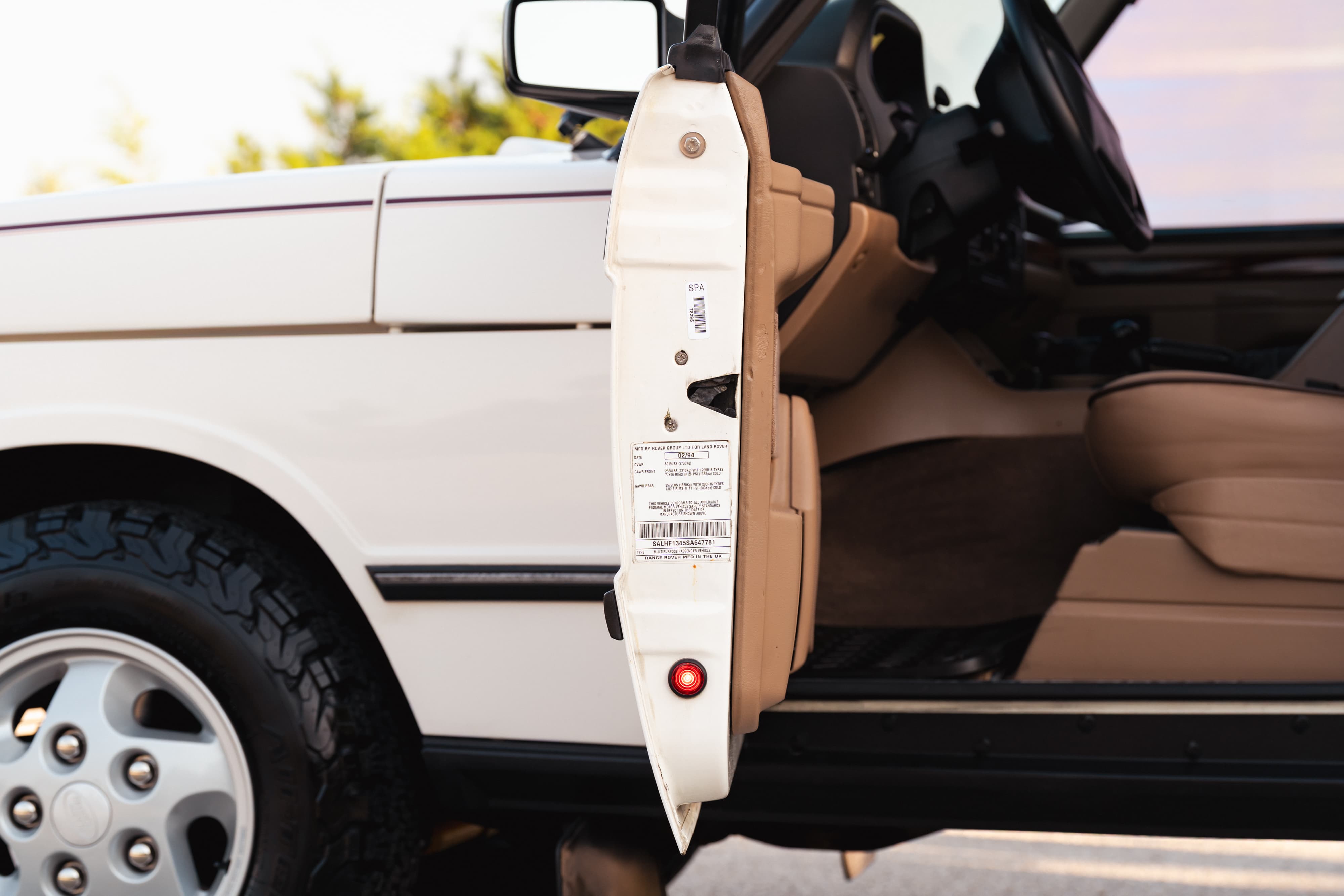 White 1995 Range Rover County interior and door jamb detail.
