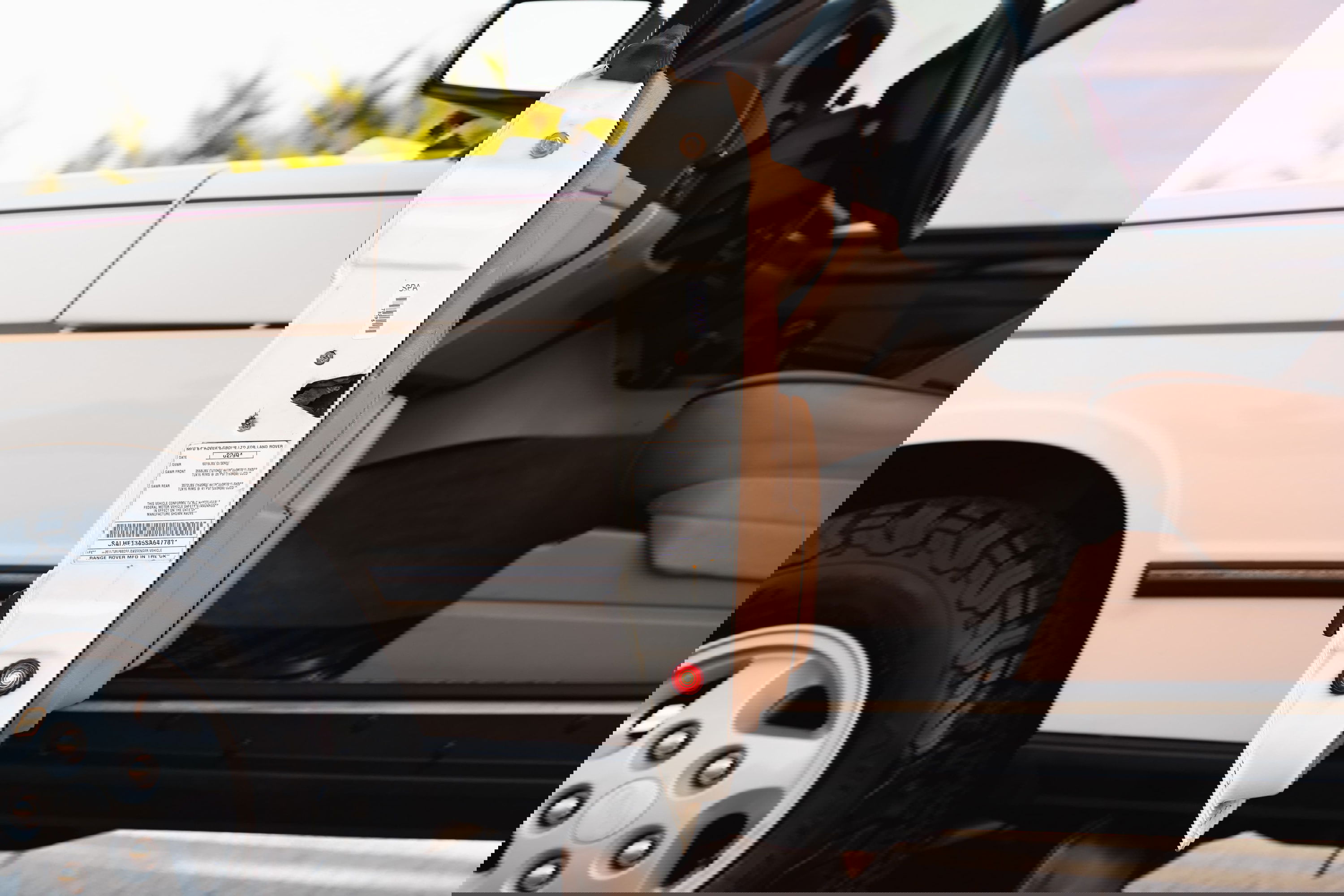 White 1995 Range Rover County interior and door jamb detail.