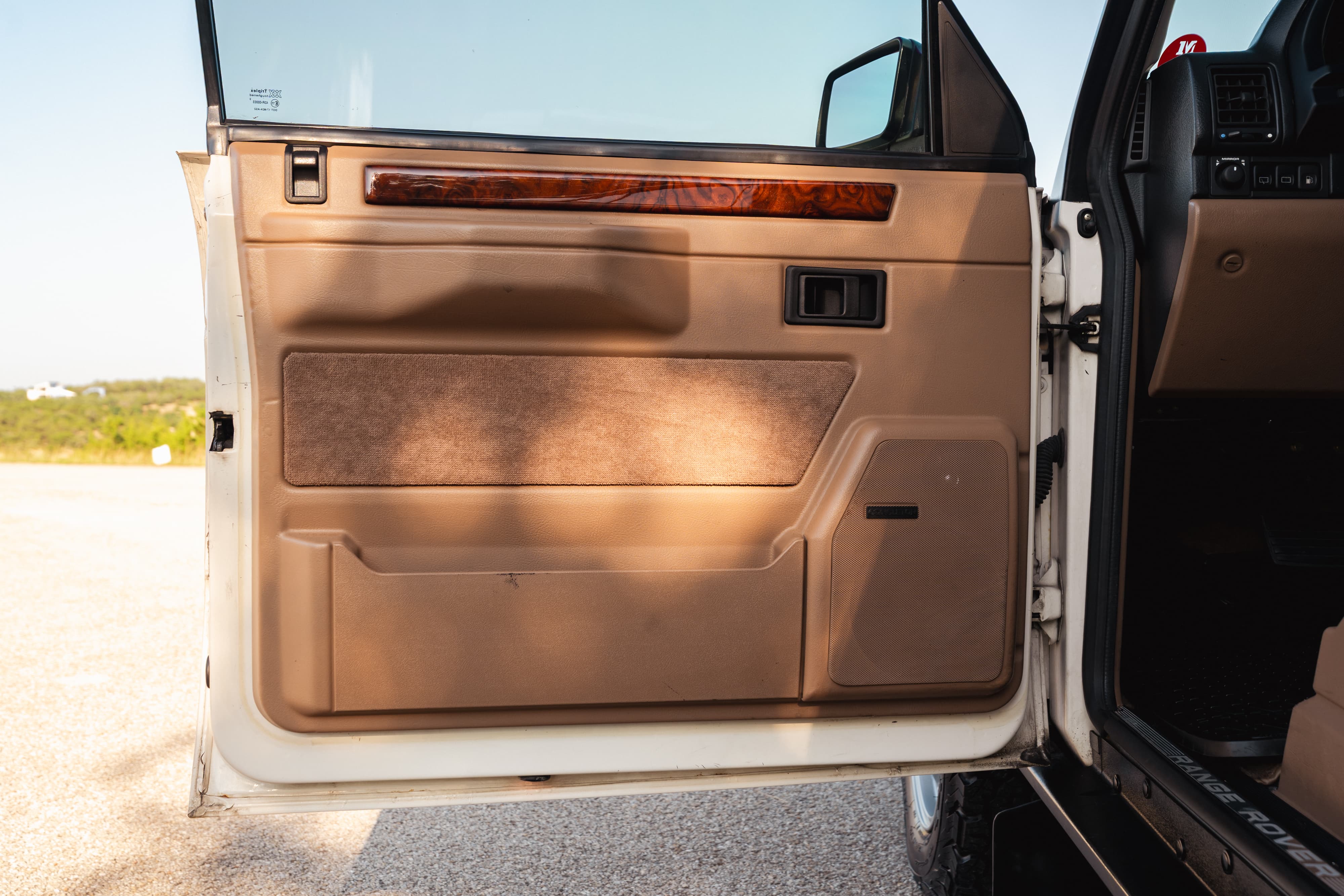 1995 Range Rover County interior door panel with wood trim and Bose speaker.