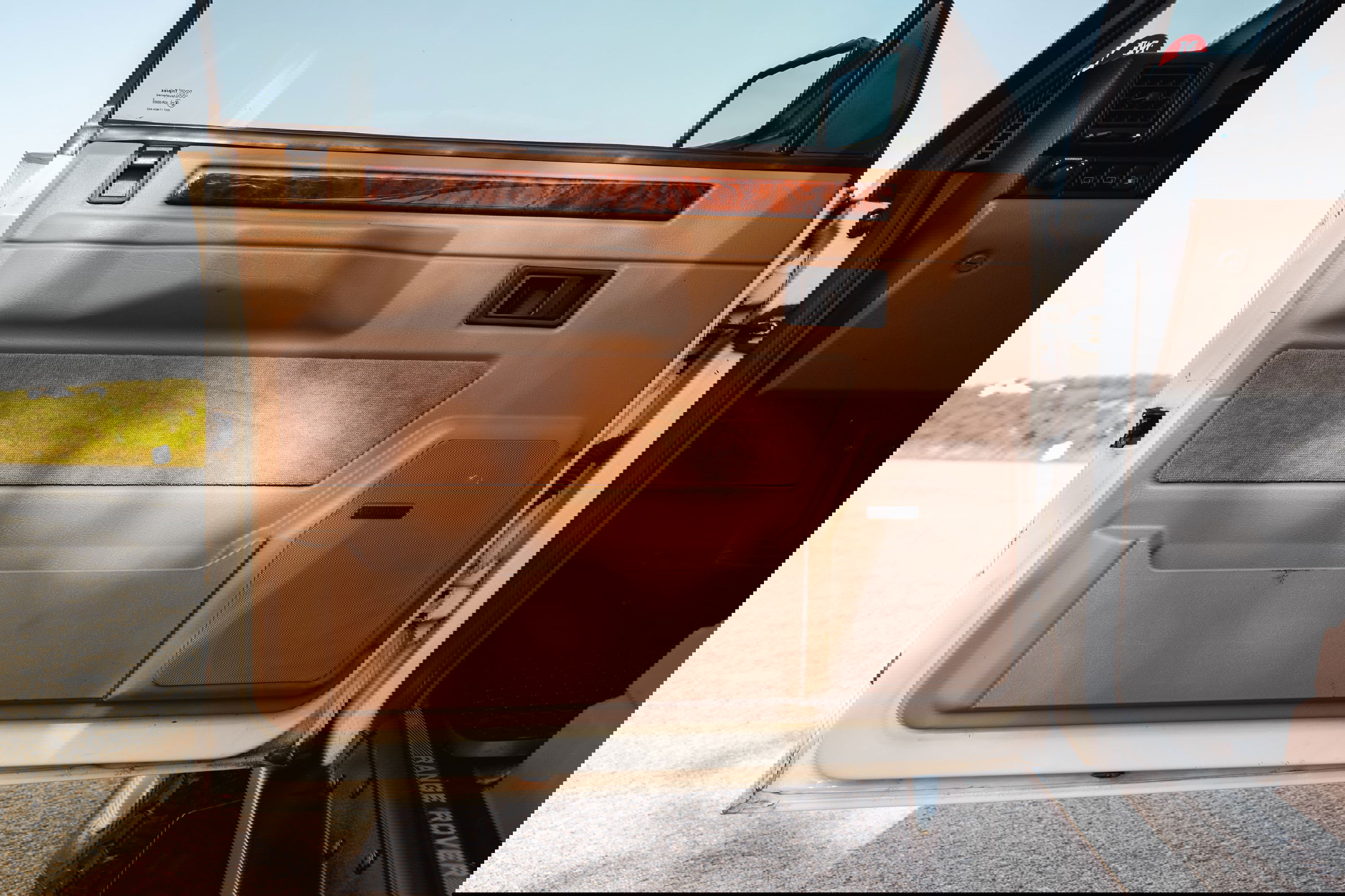 1995 Range Rover County interior door panel with wood trim and Bose speaker.