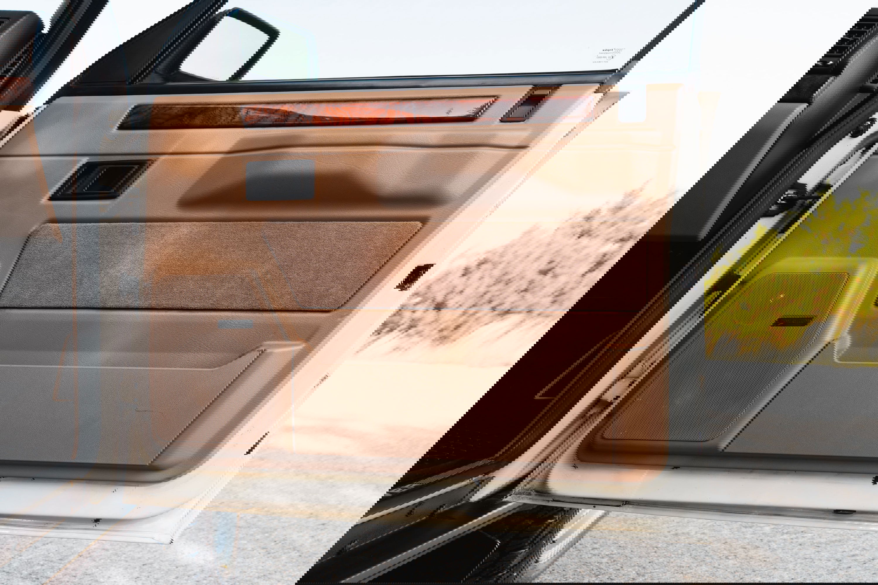 1995 white Range Rover County door panel with wood trim and Bose speaker.