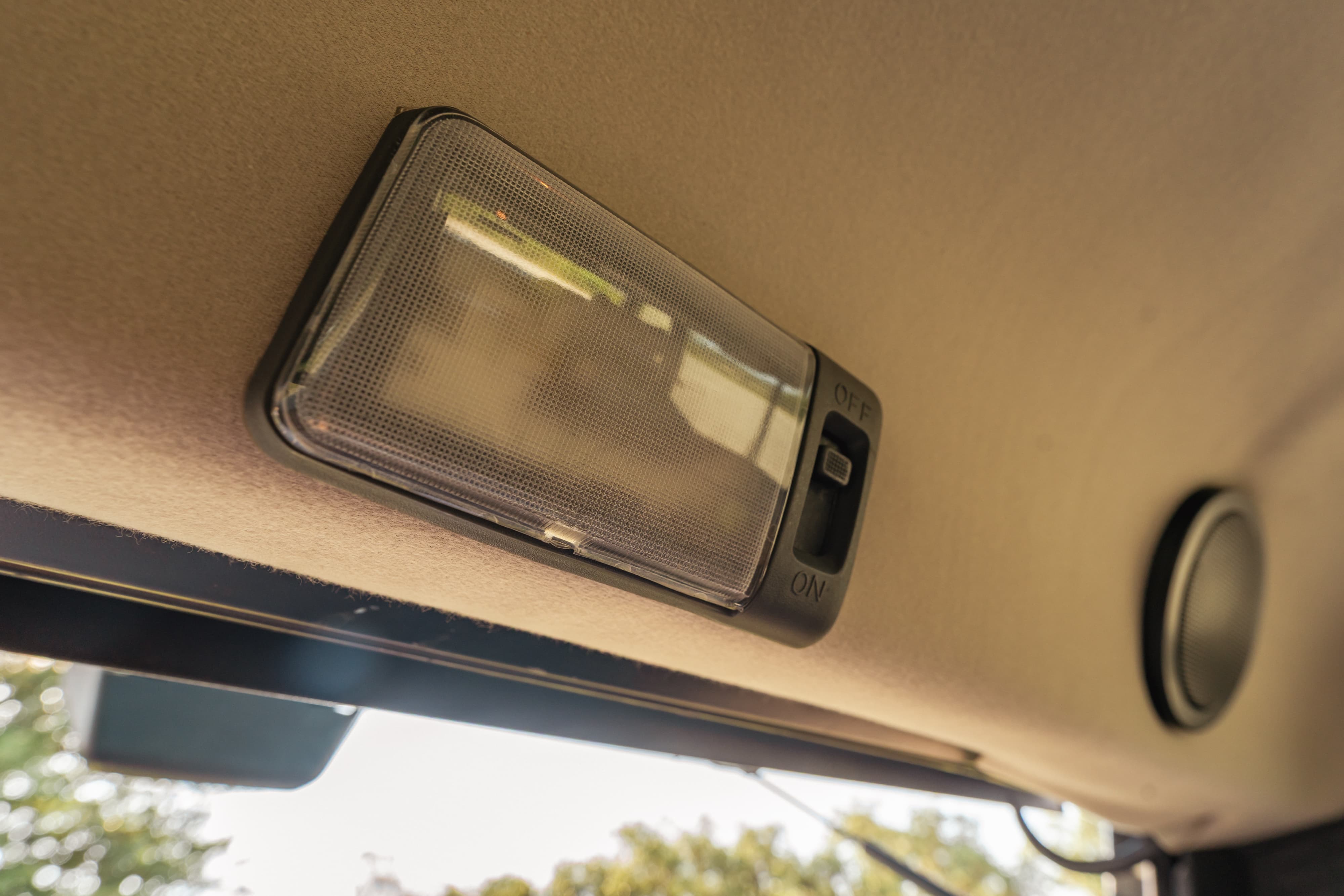 Interior dome light with ON/OFF switch on a 1995 white Land Rover Range Rover County.
