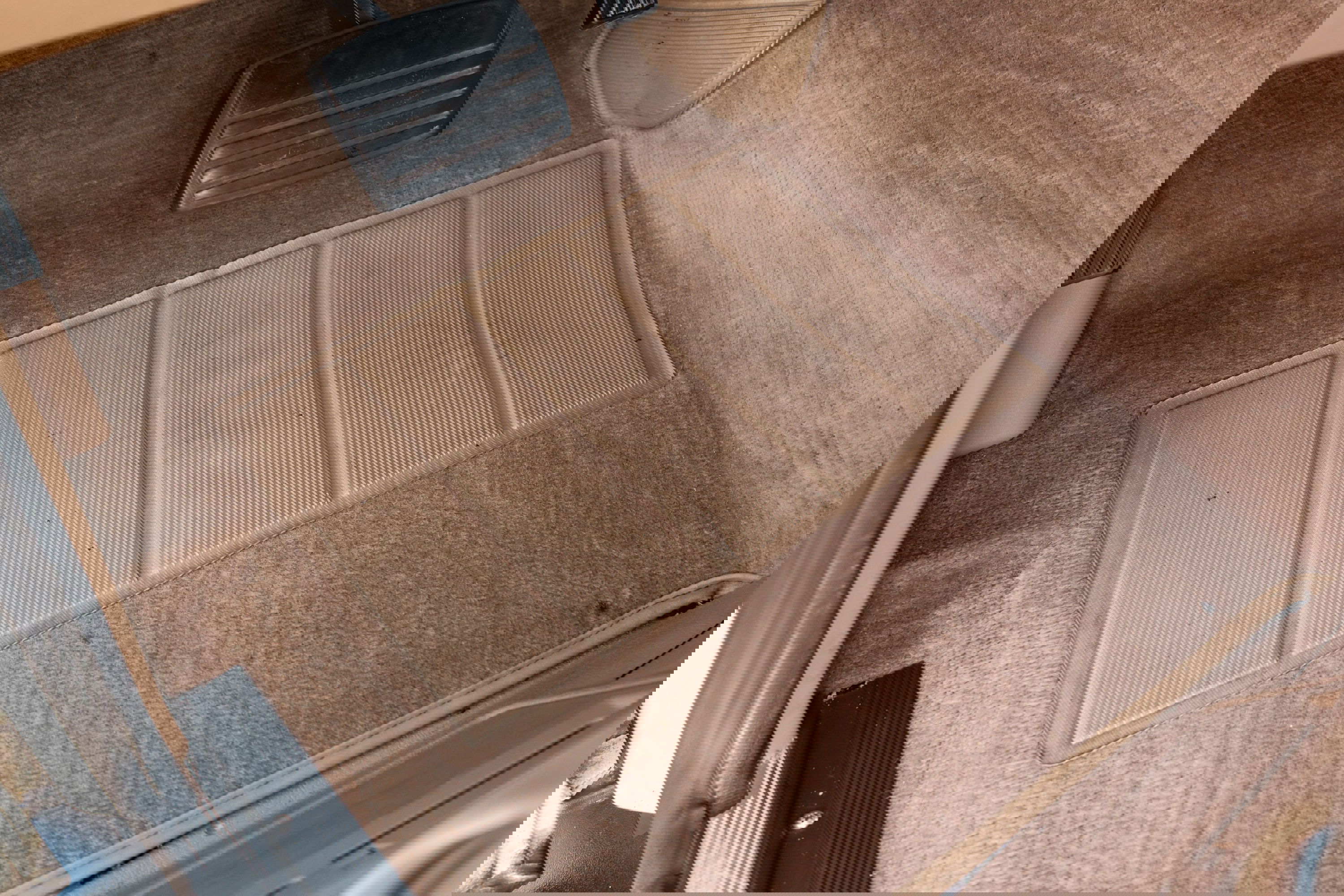 Tan carpet floor mat and pedals in a 1995 Range Rover County.