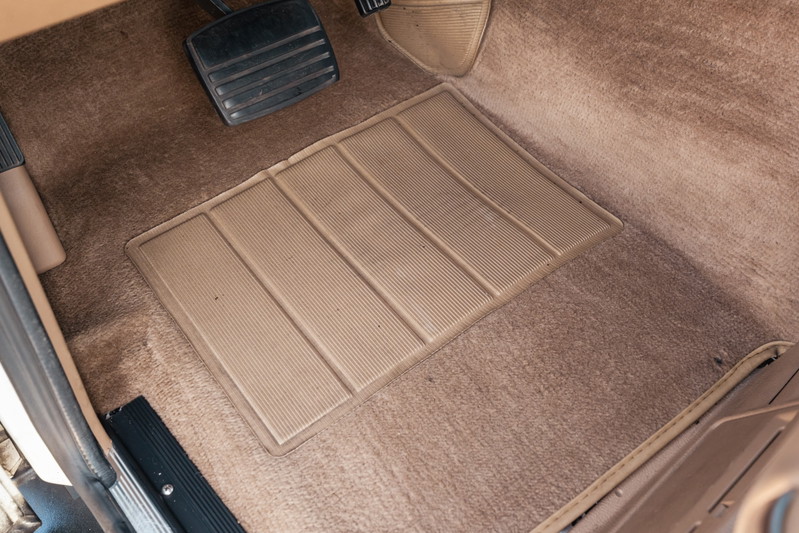 Tan carpet floor mat and pedals in a 1995 Range Rover County.