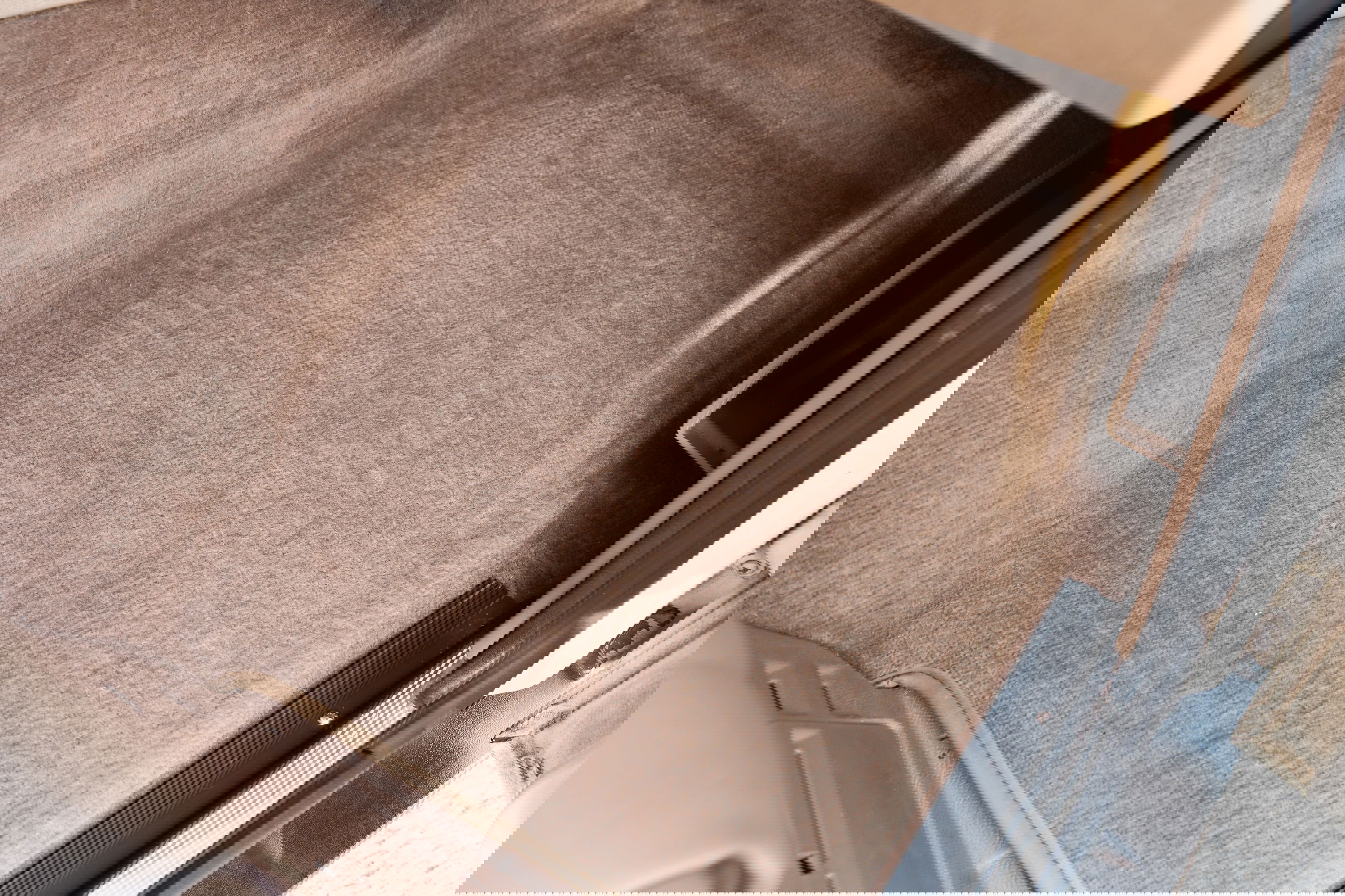 Tan carpet and trim on the floor of a white 1995 Land Rover Range Rover County.