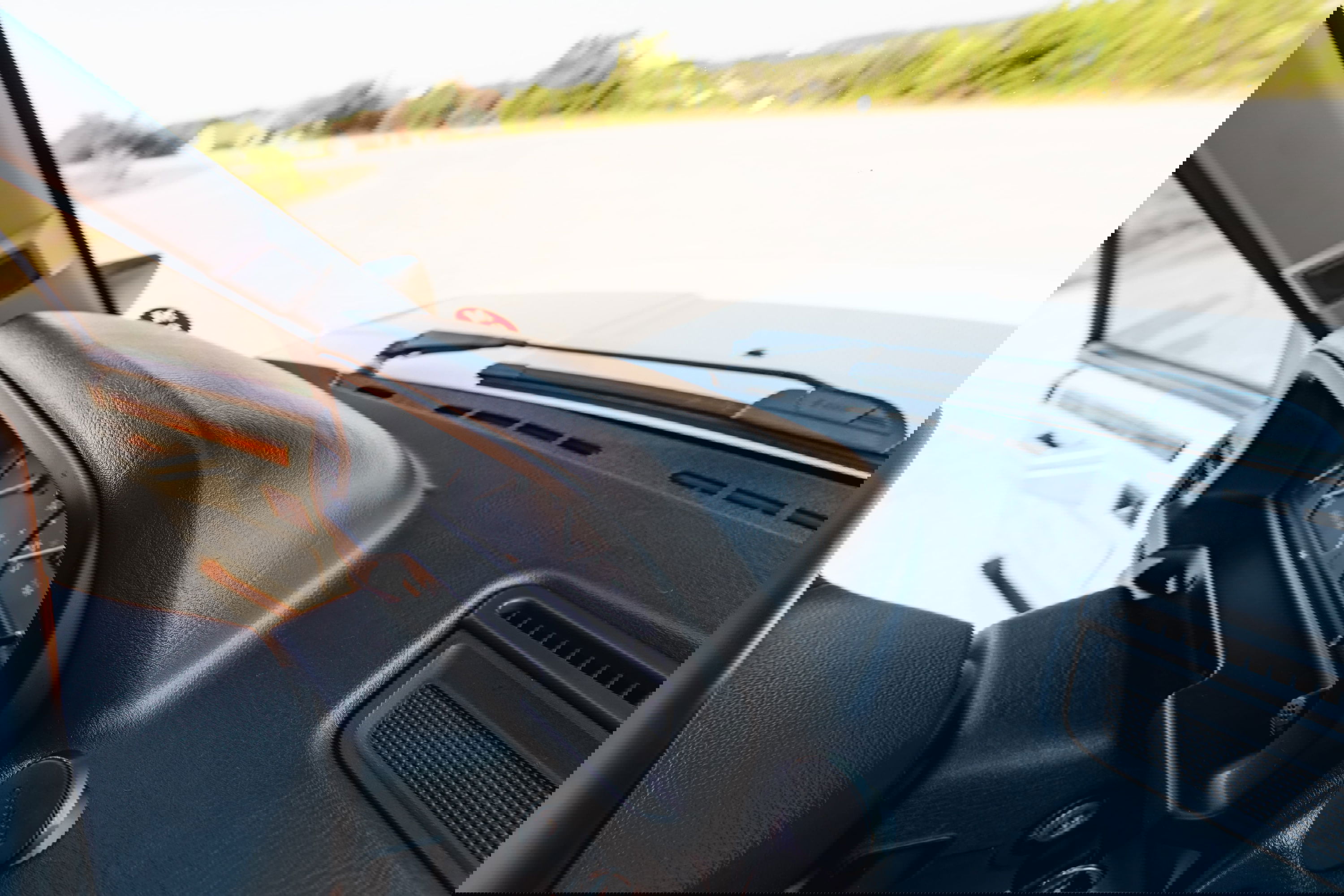 Interior view of a white 1995 Land Rover Range Rover County dashboard with analog gauges and wood trim.