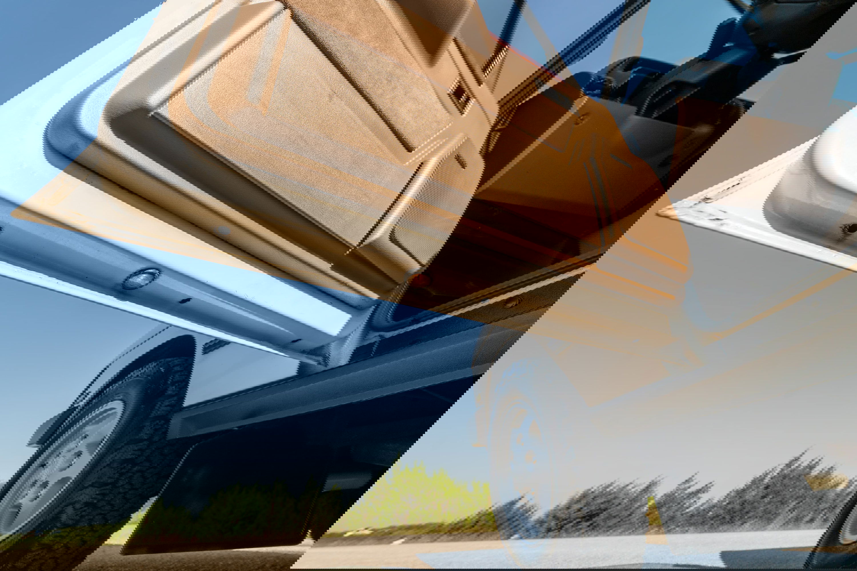 1995 white Land Rover Range Rover County door open, showing tan trim and wheel.