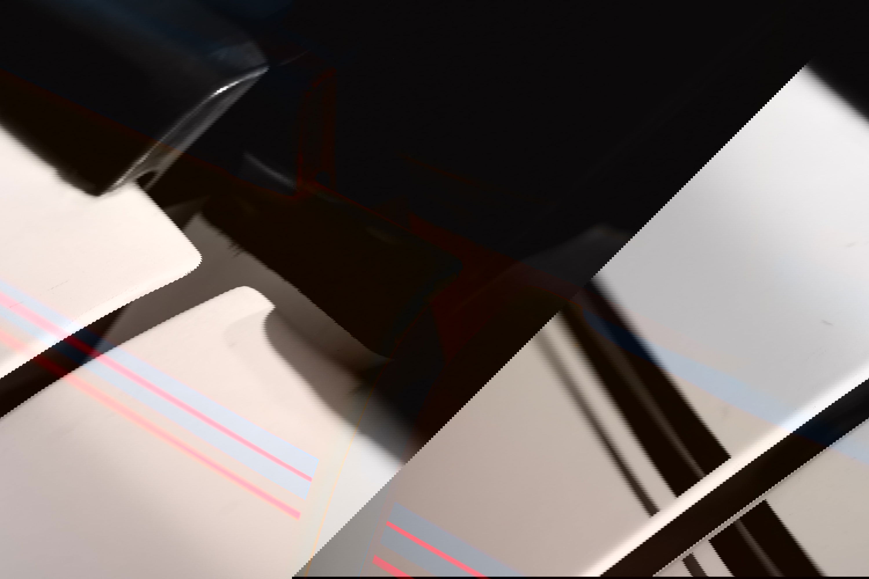 Close-up of a white 1995 Range Rover County with racing stripes on the door trim.