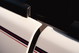 Close-up of a white 1995 Range Rover County with racing stripes on the door trim.