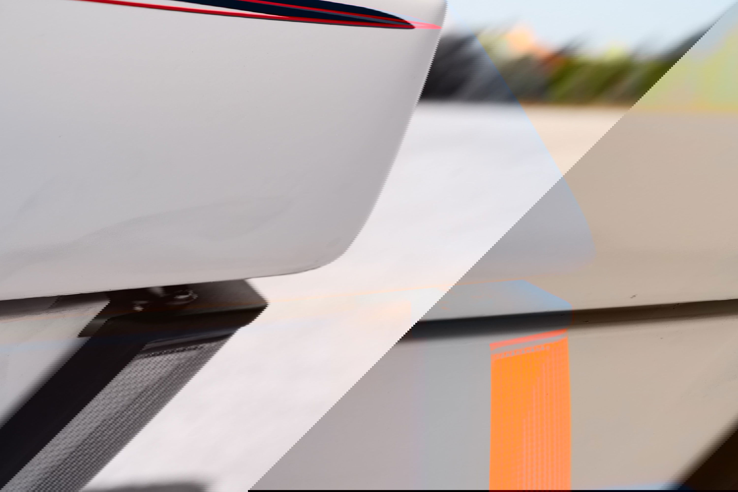 White 1995 Range Rover County with red & blue stripe livery detail and amber marker light.