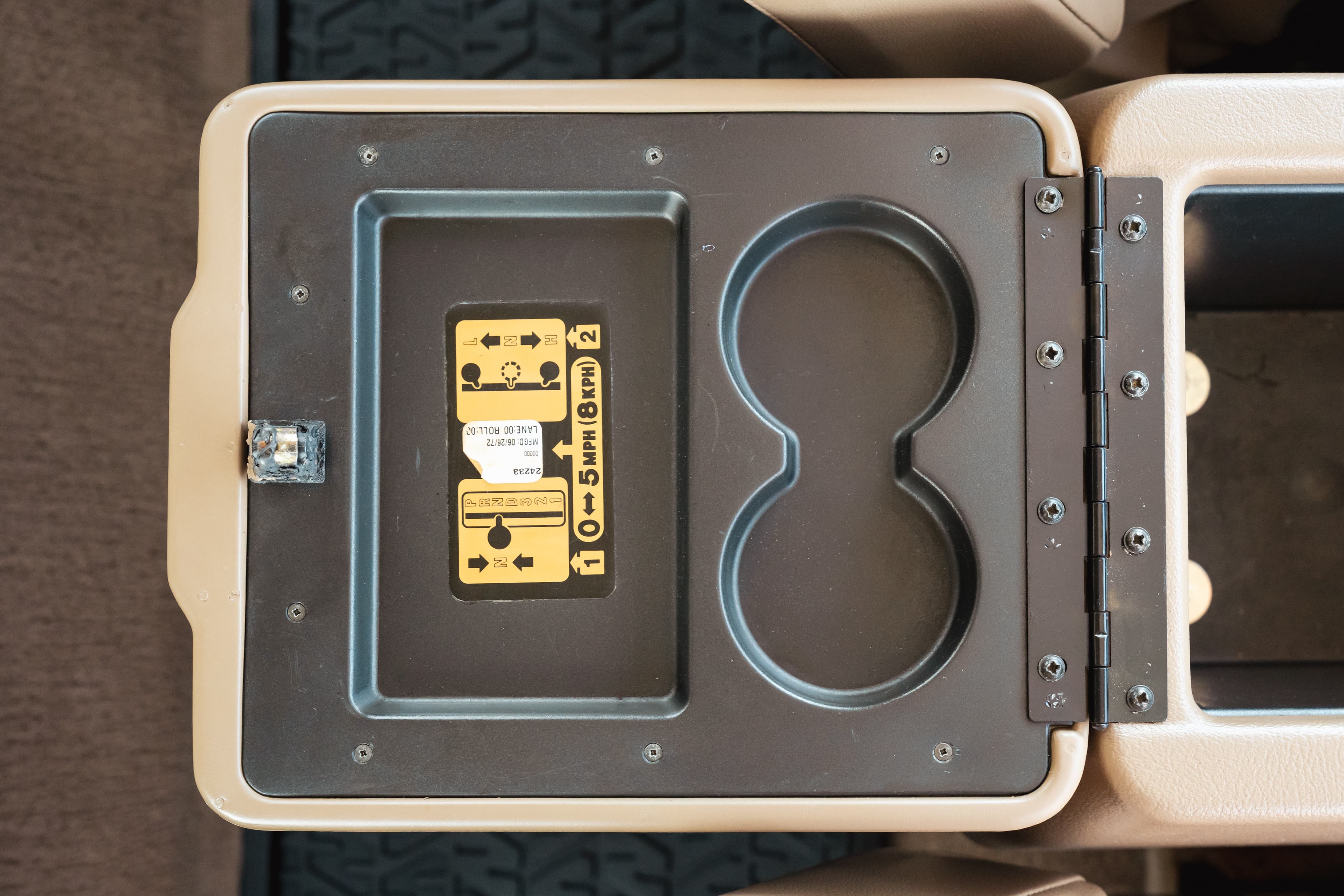 1995 white Land Rover Range Rover County center console with cup holders and warning label.