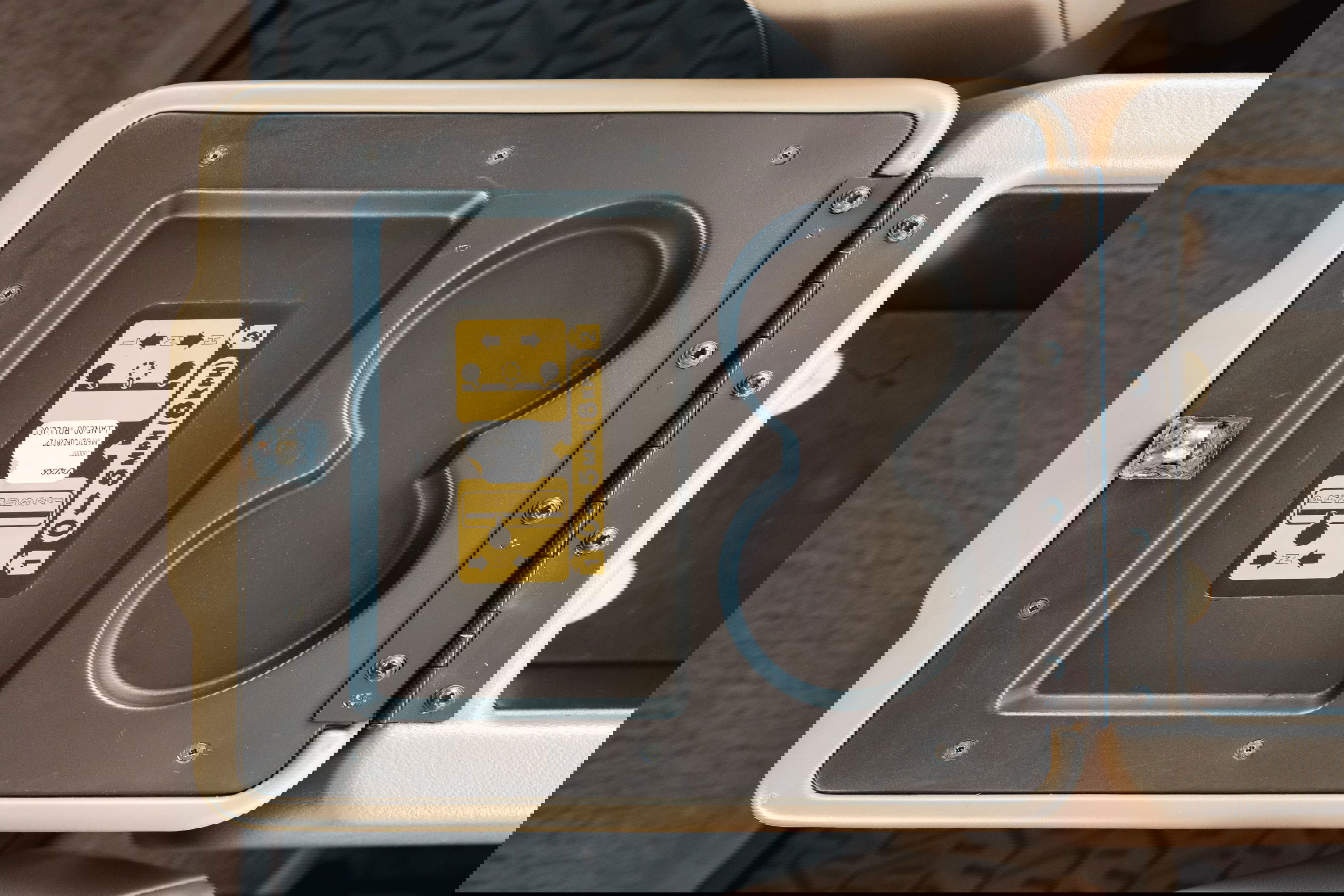 1995 white Land Rover Range Rover County center console with cup holders and warning label.