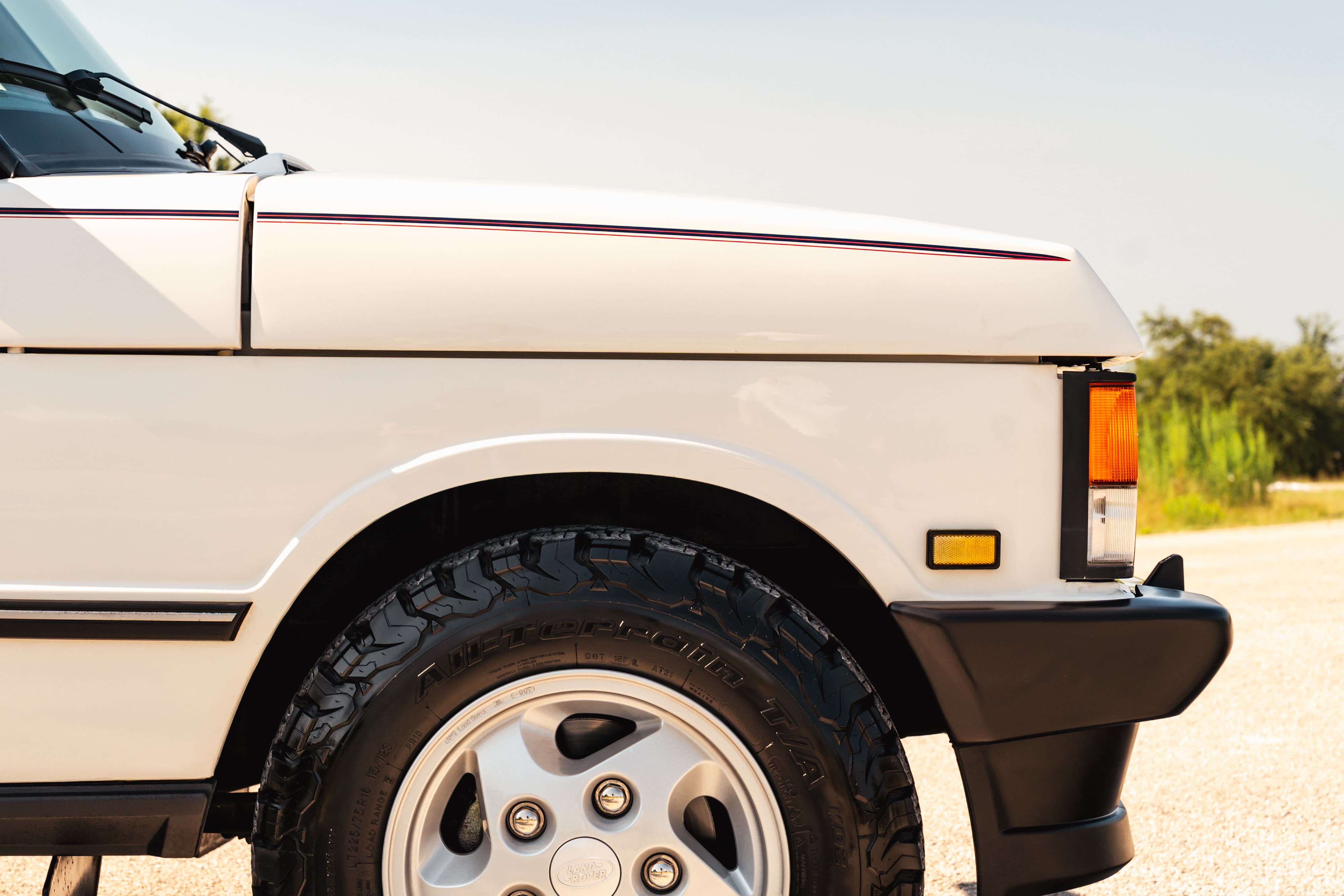 White 1995 Land Rover Range Rover County with subtle pinstripe trim and alloy rims.