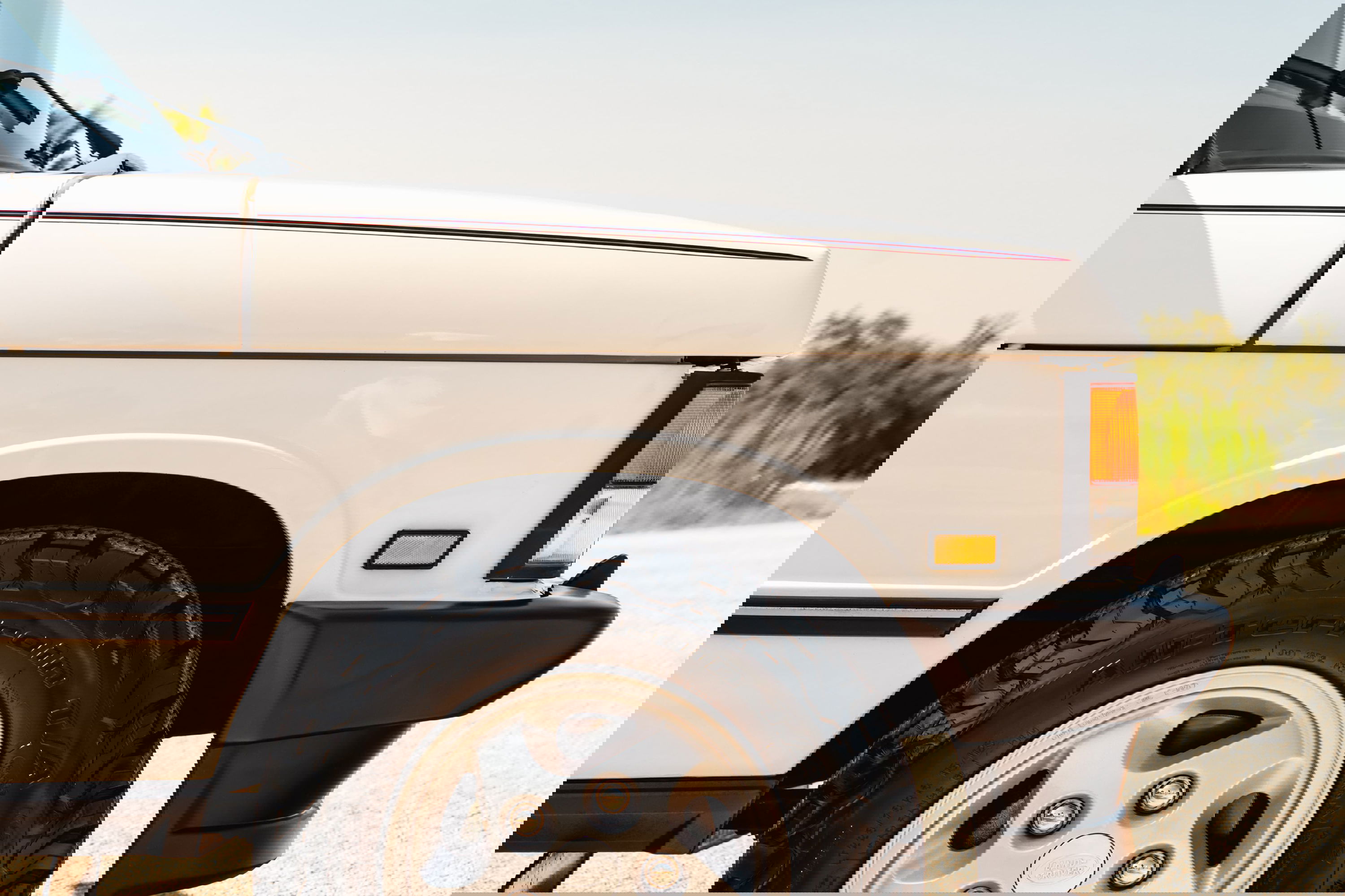 White 1995 Land Rover Range Rover County with subtle pinstripe trim and alloy rims.