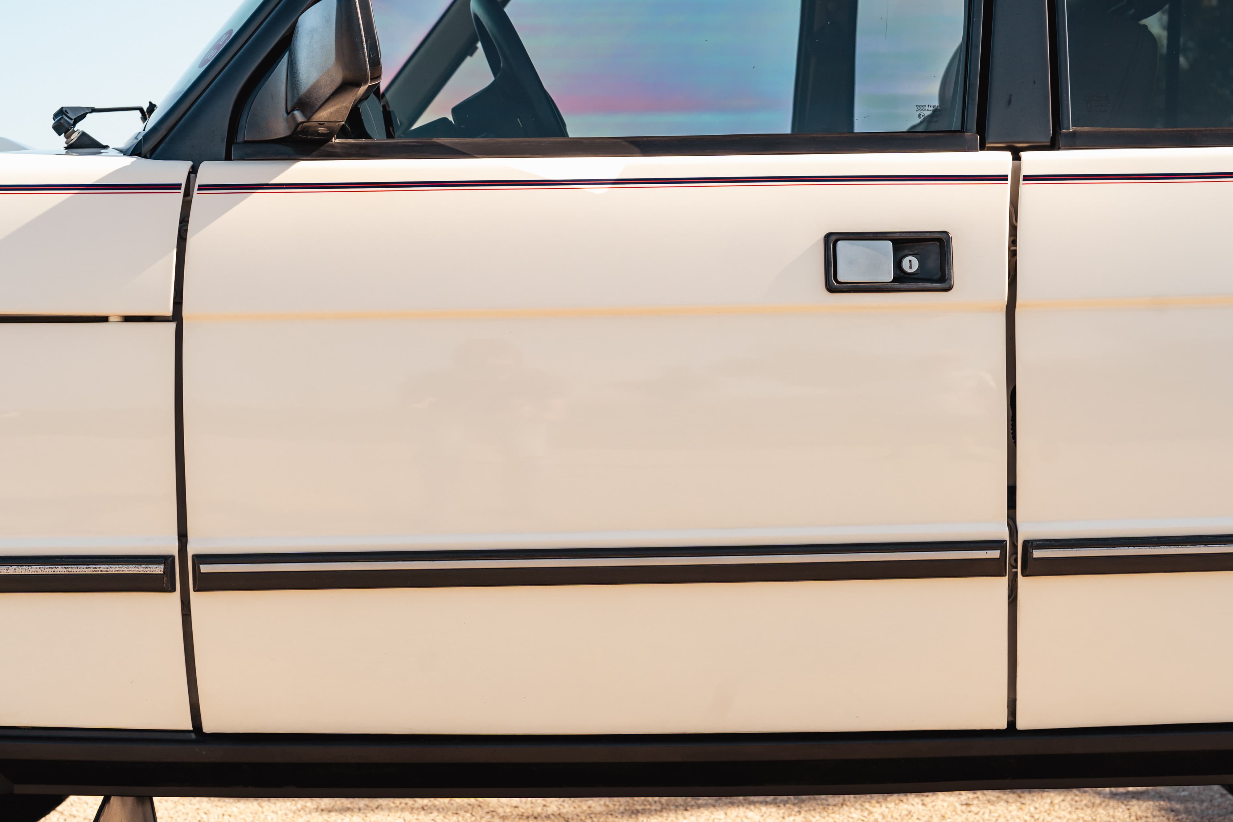 White 1995 Land Rover Range Rover County side door with chrome trim.