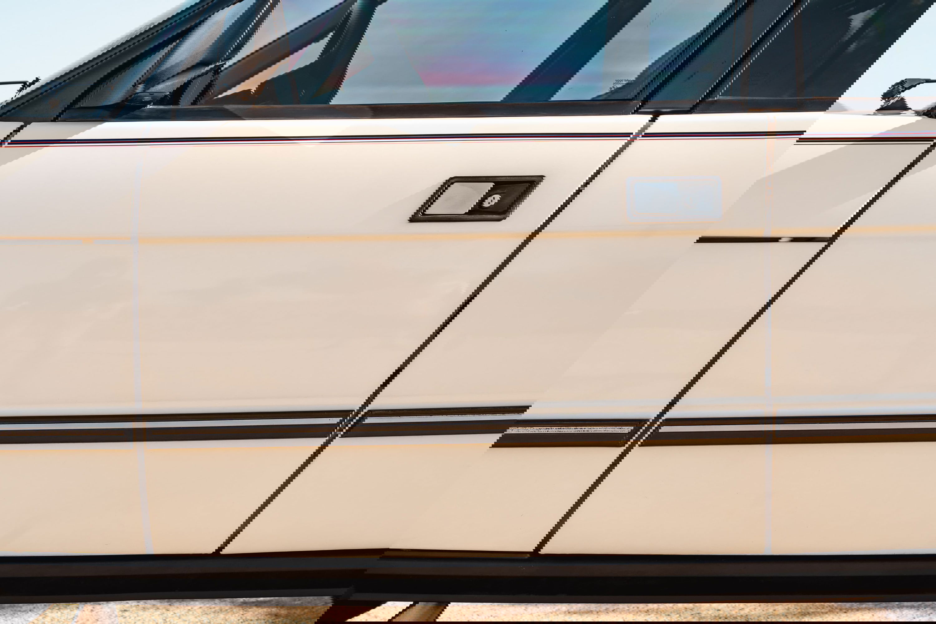 White 1995 Land Rover Range Rover County side door with chrome trim.