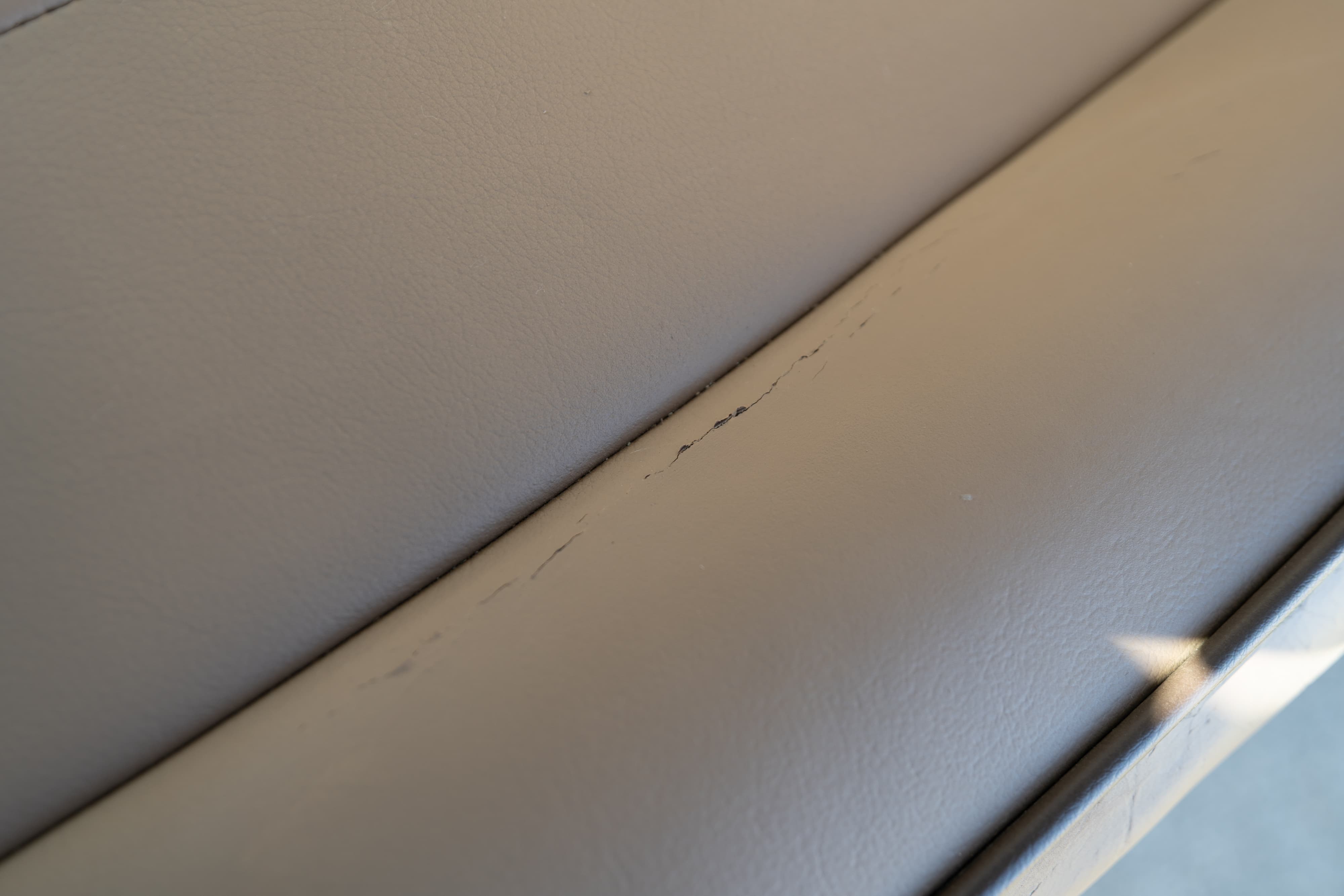 Cracked beige interior trim on a 1995 white Land Rover Range Rover County.