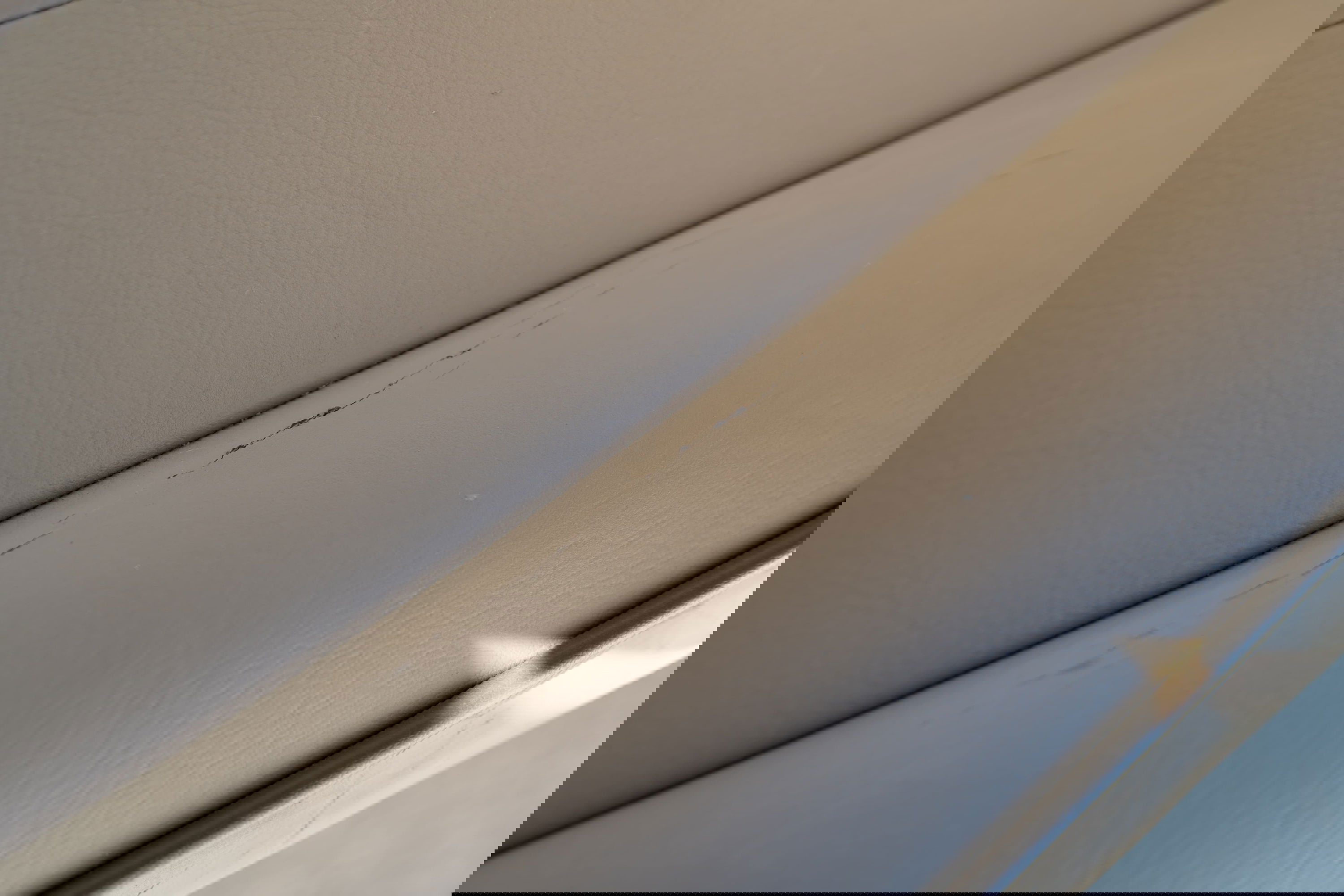 Cracked beige interior trim on a 1995 white Land Rover Range Rover County.