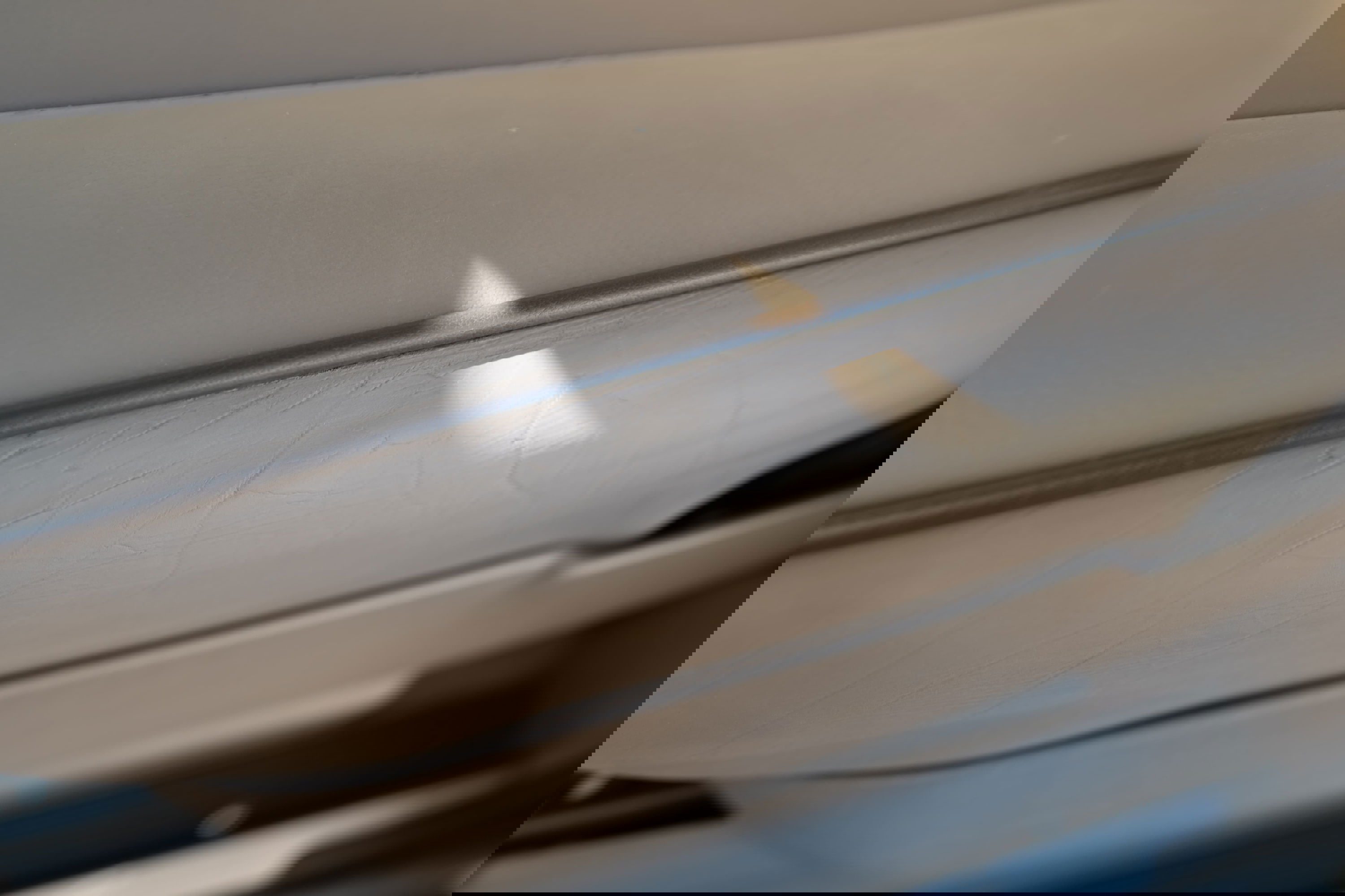 Tan interior trim detail on a 1995 Range Rover County, showing subtle texture and sunlight highlights.