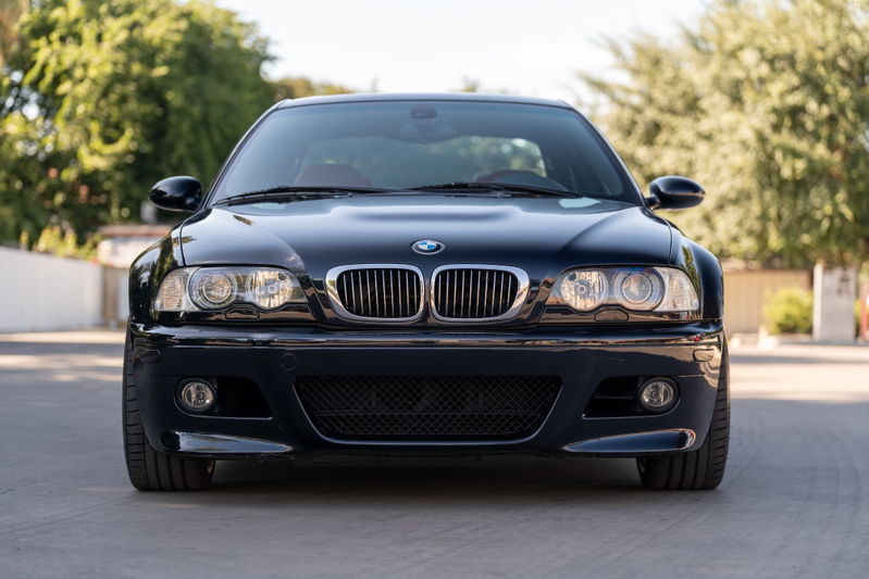 Front view of a black 2002 BMW M3 with chrome kidney grille and round headlights.