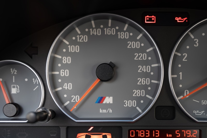 Dashboard of a carbon black 2002 BMW M3. Speedometer shows 20 km/h.