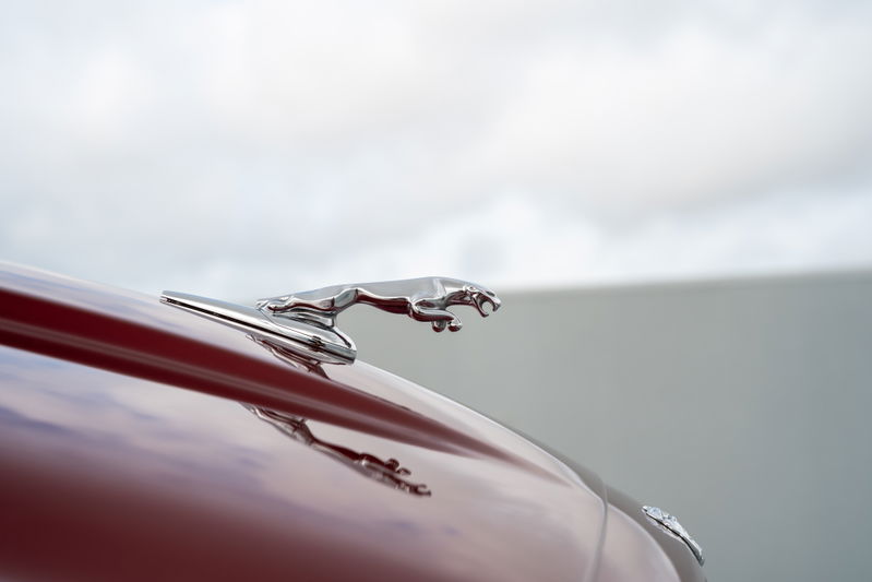 Radiance Red 2006 Jaguar XJR chrome hood ornament.