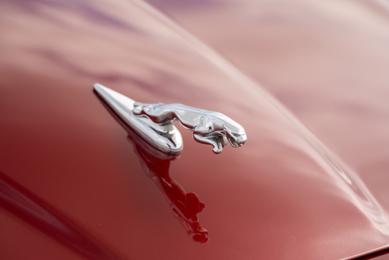 Radiance Red 2006 Jaguar XJR hood ornament with chrome trim.