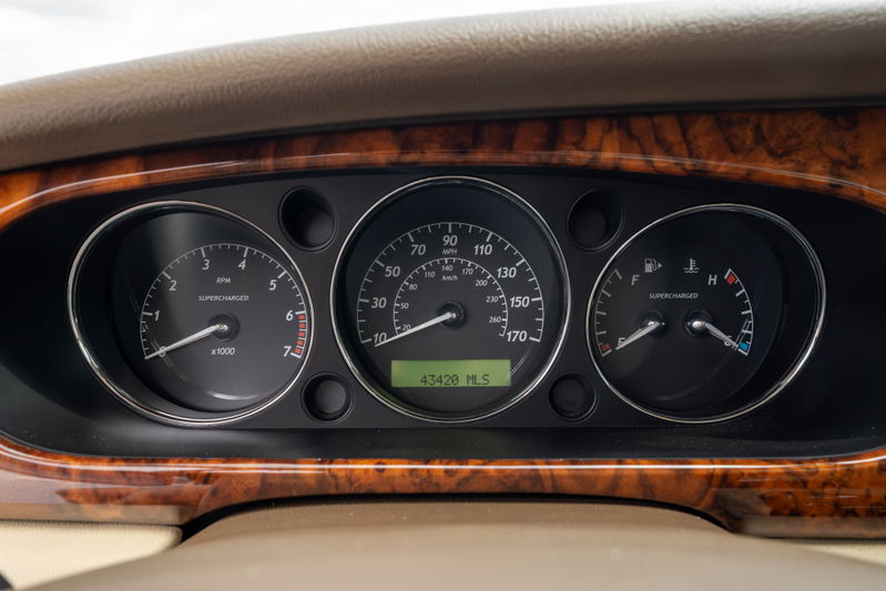 2006 Jaguar XJR dashboard with wood trim, showing 43,420 miles.
