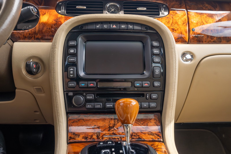 2006 Jaguar XJR interior with wood trim, leather accents, and a wood shift knob.