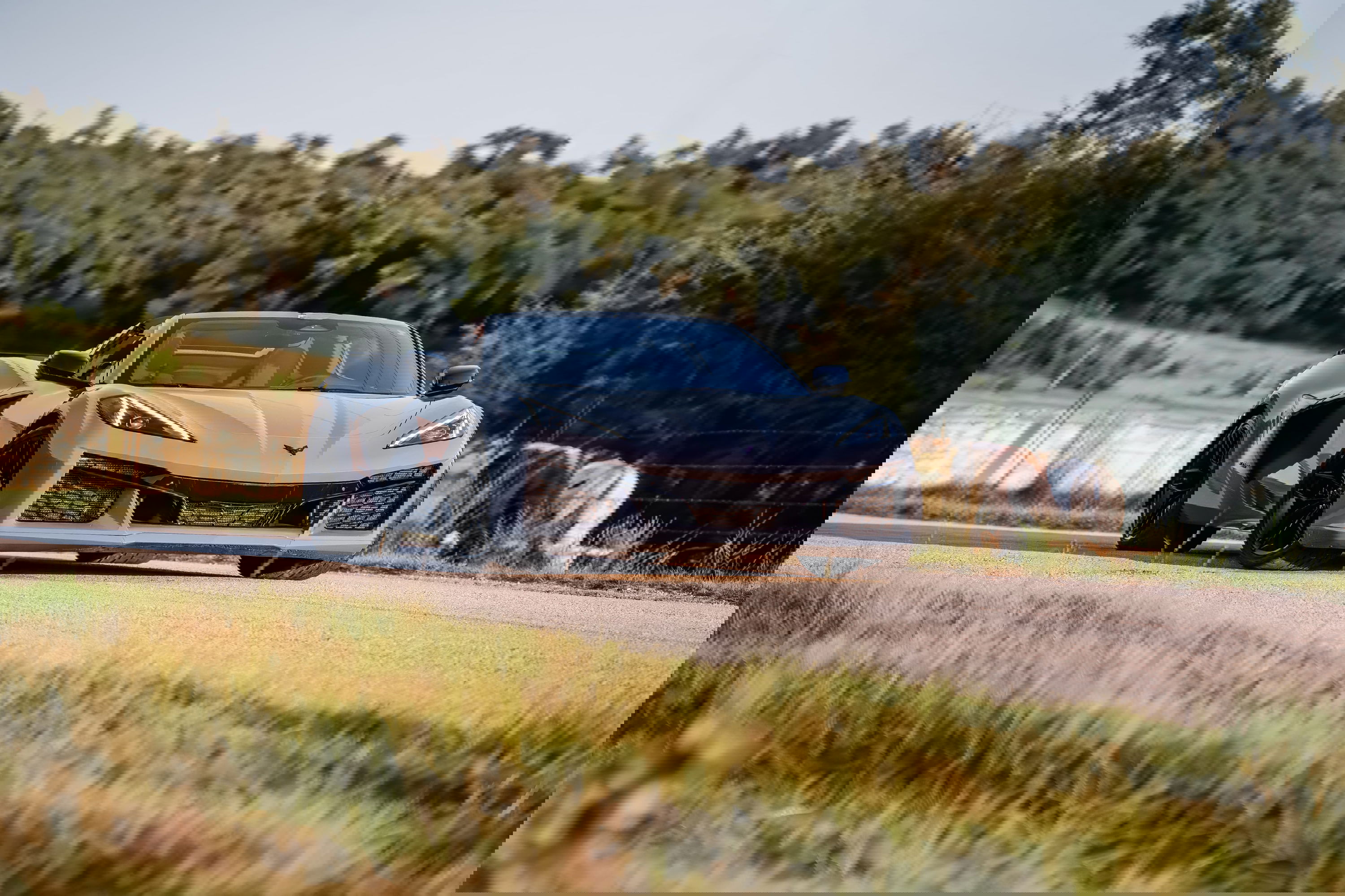 Sea Wolf Gray 2025 Corvette Z06 convertible with black rims parked on a rural road.