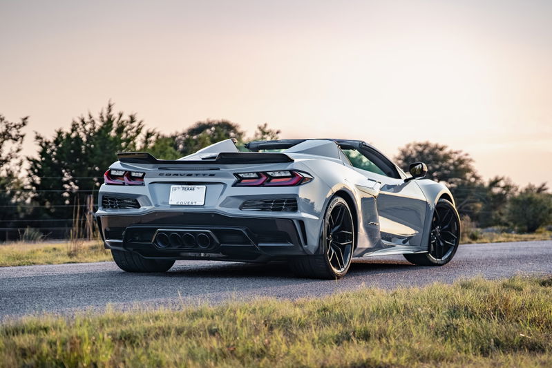 Rear view of a Sea Wolf Gray 2025 Chevrolet Corvette Z06 convertible with black rims and a prominent rear spoiler.