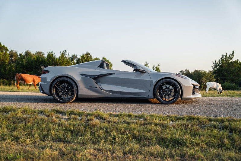 2025 Corvette Z06 convertible in Sea Wolf Gray, black rims, low profile tires, rear spoiler.