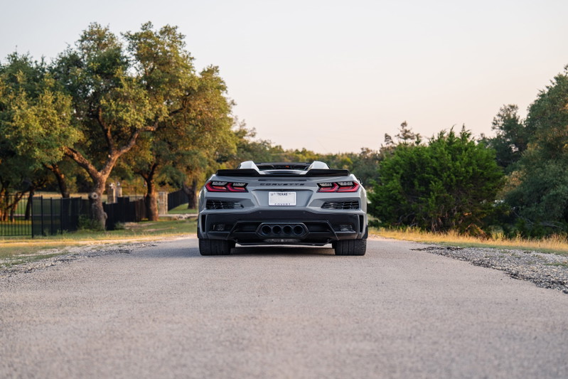 Rear view of a gray 2025 Chevrolet Corvette Z06 convertible with quad exhaust tips.