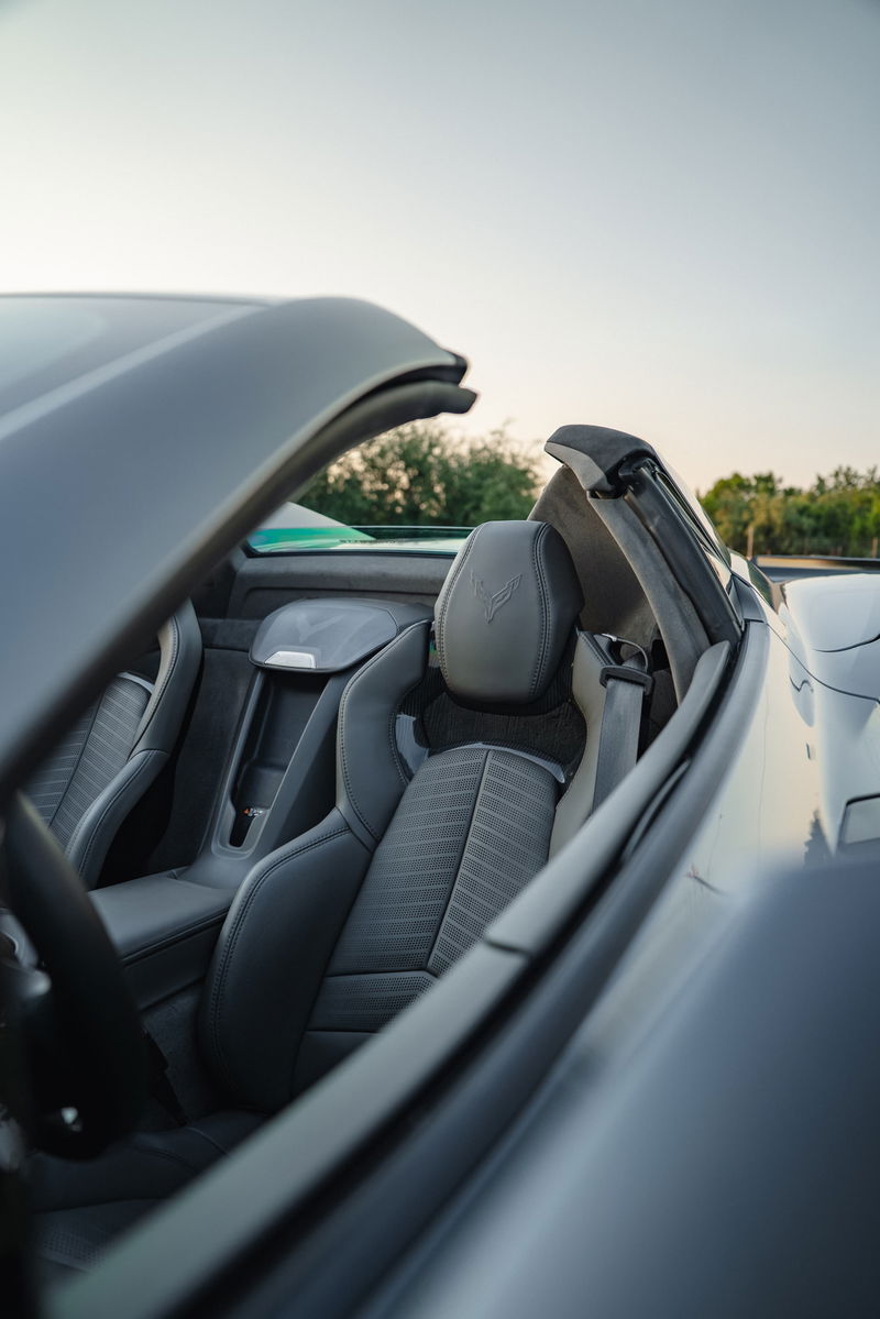 2025 Chevrolet Corvette Z06 convertible interior in Sea Wolf Gray, featuring leather seats with embossed crossed flags.