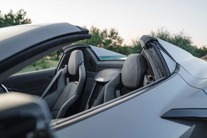 Gray 2025 Chevrolet Corvette Z06 convertible interior with embossed seat emblems.