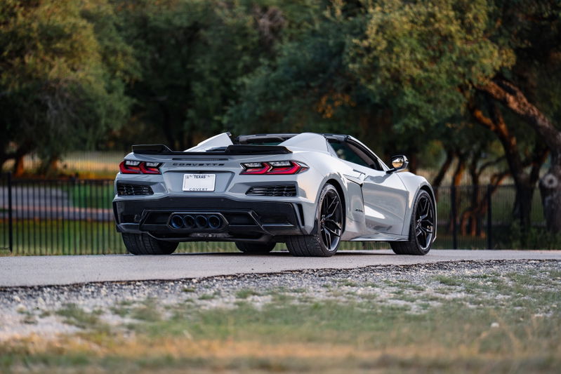 Rear view of a Sea Wolf Gray 2025 Chevrolet Corvette Z06 convertible with black rims and trim.