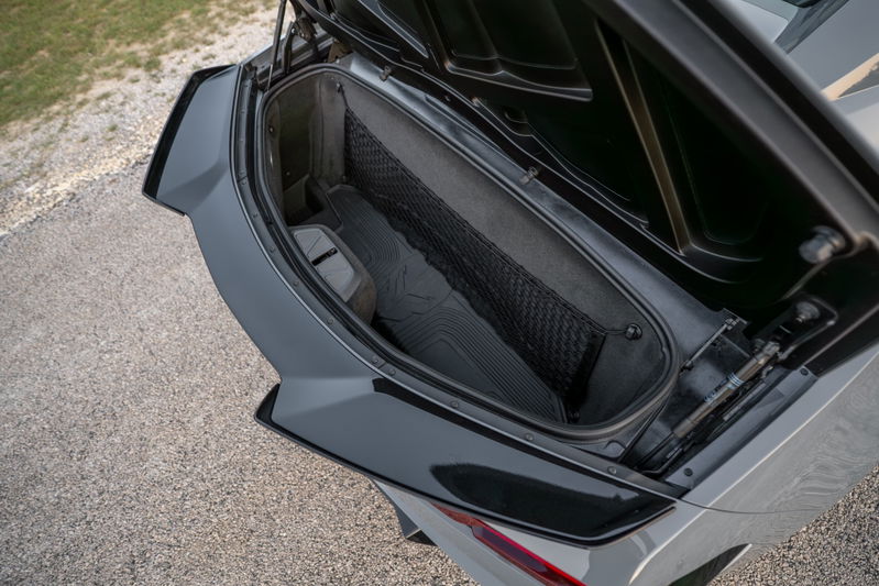 Gray 2025 Corvette Z06 trunk with cargo net and floor mats.