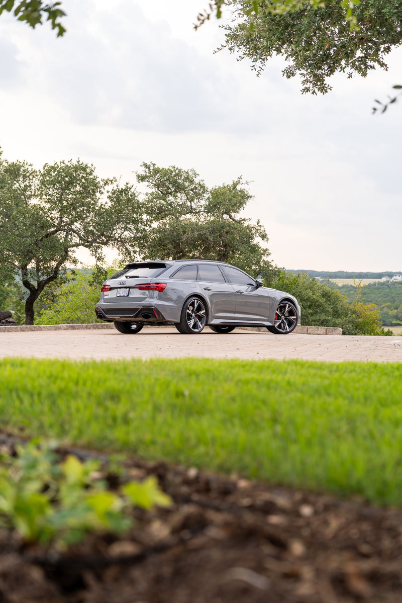 Nardo Grey 2022 Audi RS6 Avant with gloss black rims and red brake calipers.