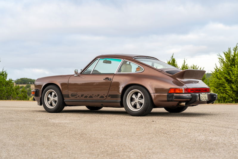 1975 Porsche 911 Carrera in Copper Brown Metallic with black side livery and Fuchs rims.