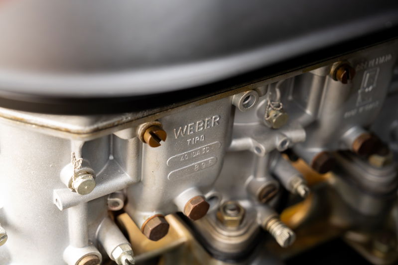 Close-up of a vintage Weber carburetor on a 1975 Porsche 911 Carrera.