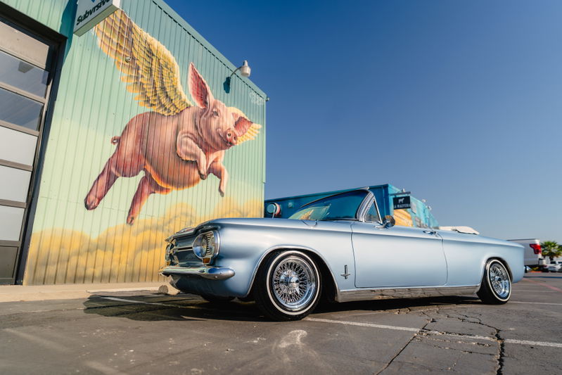 1966 Chevrolet Corvair convertible in blue metallic, with wire-spoke rims.