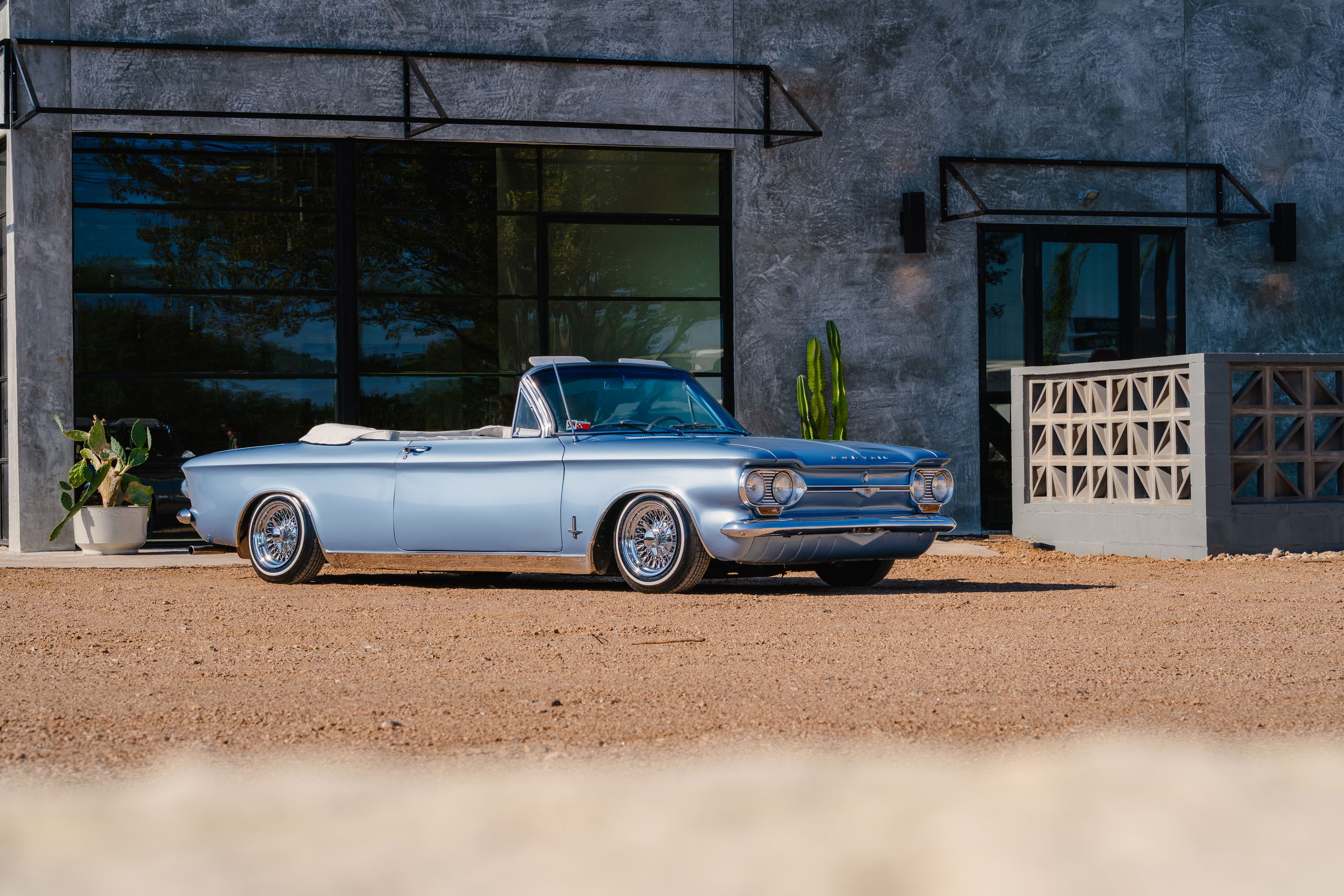1966 Chevrolet Corvair convertible, blue metallic paint, chrome trim, wire-spoke rims.