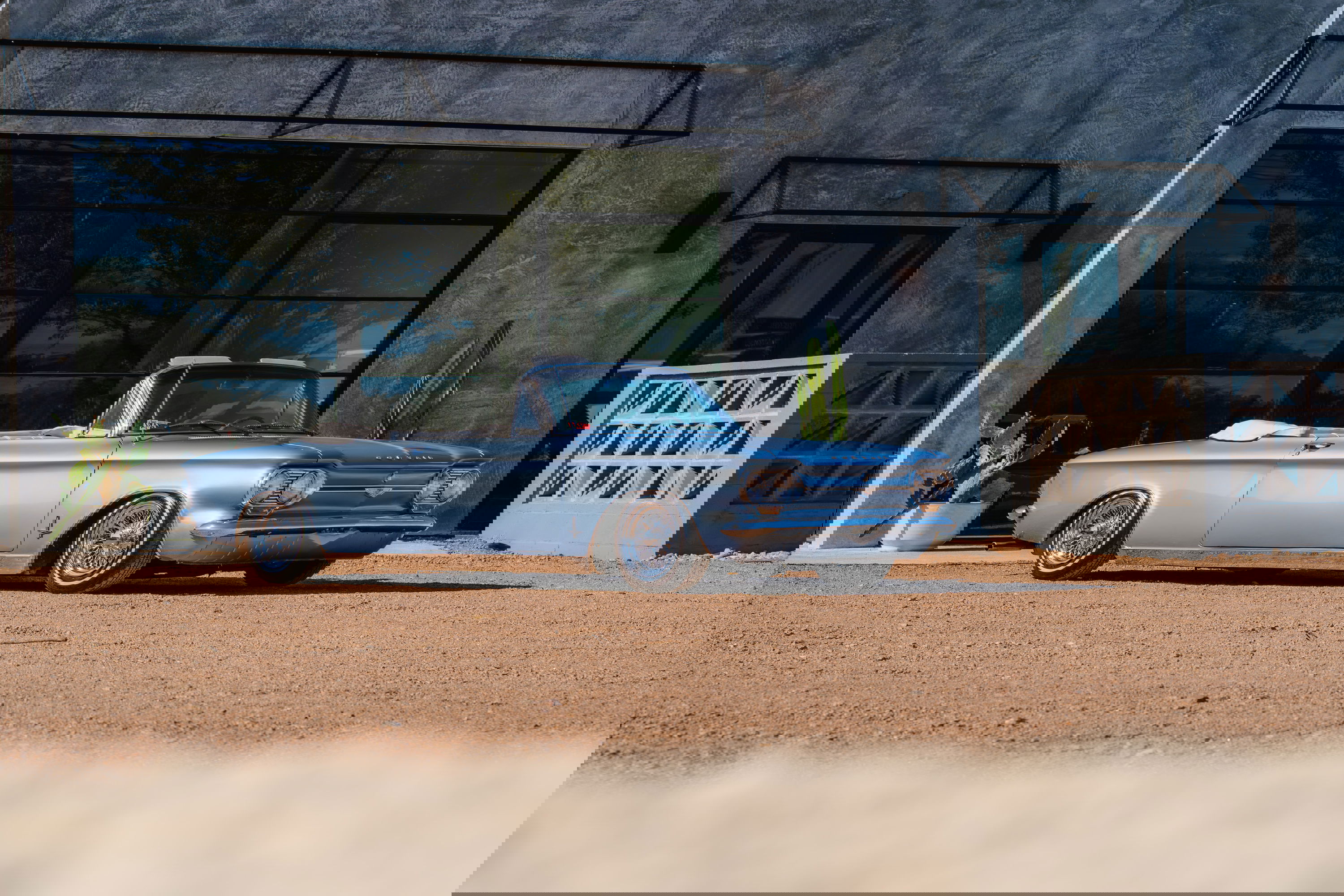 1966 Chevrolet Corvair convertible, blue metallic paint, chrome trim, wire-spoke rims.