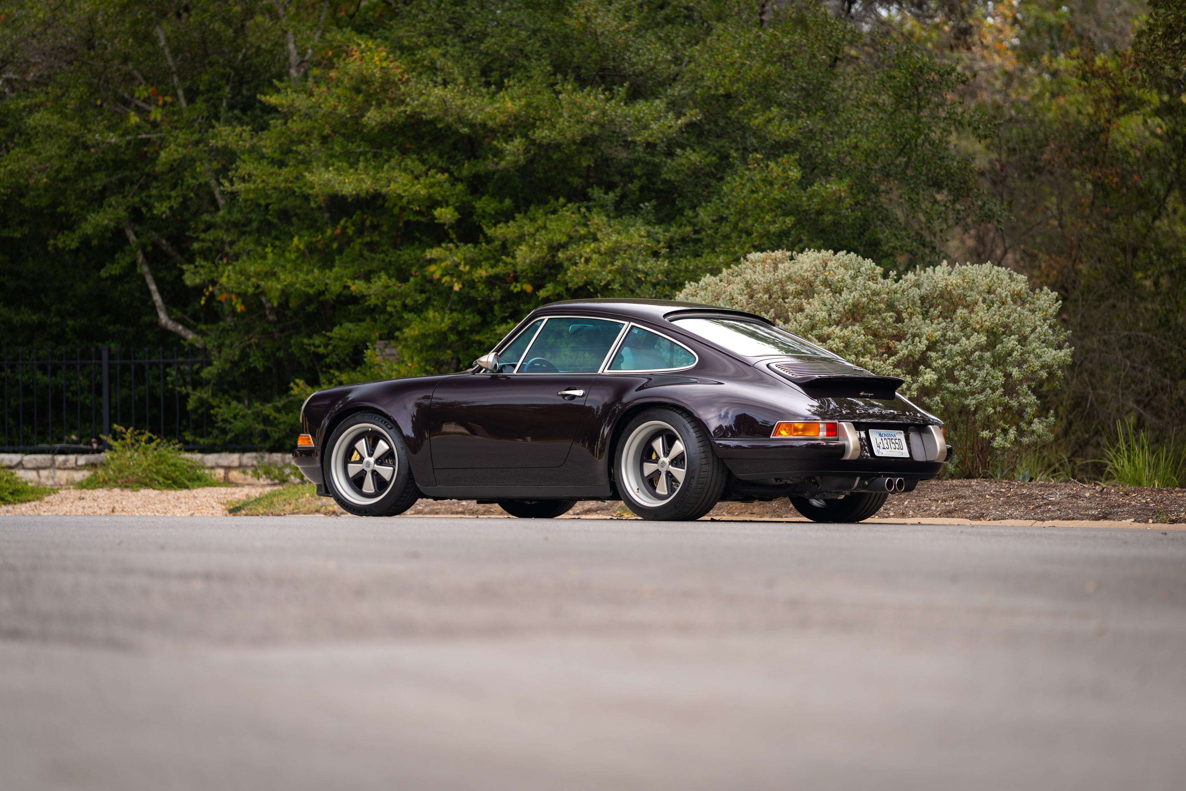Aubergine Metallic 1990 Singer 911 with Fuchs rims and ducktail spoiler.