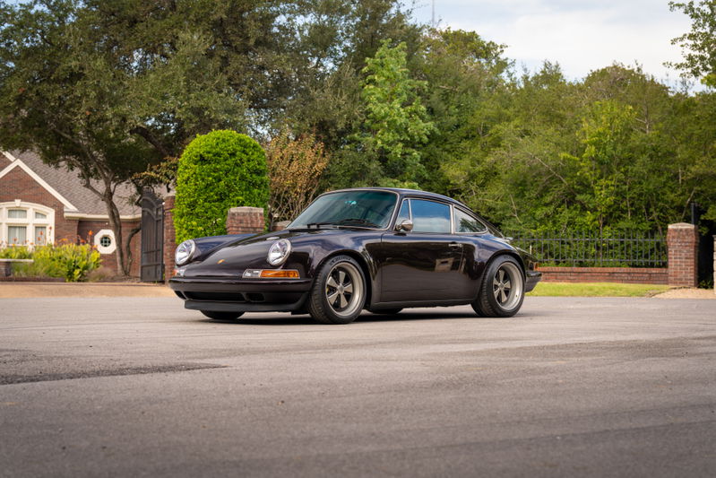 Aubergine Metallic 1990 Singer Porsche 911 with Fuchs-style rims and chrome trim.